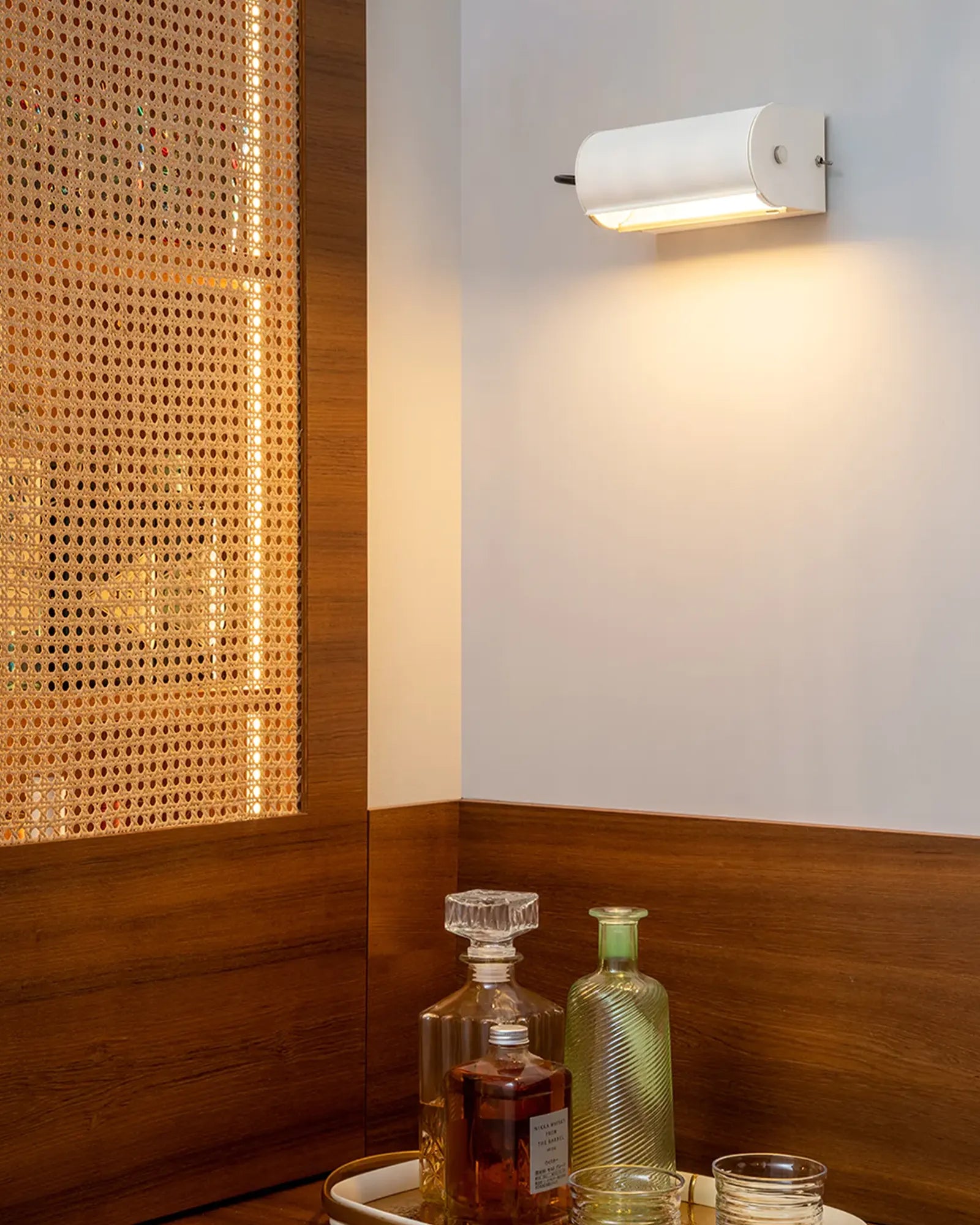Applique Cylindrique Petite Wall Light in White by Nemo Lighting featured above a bar nook | Nook Collections