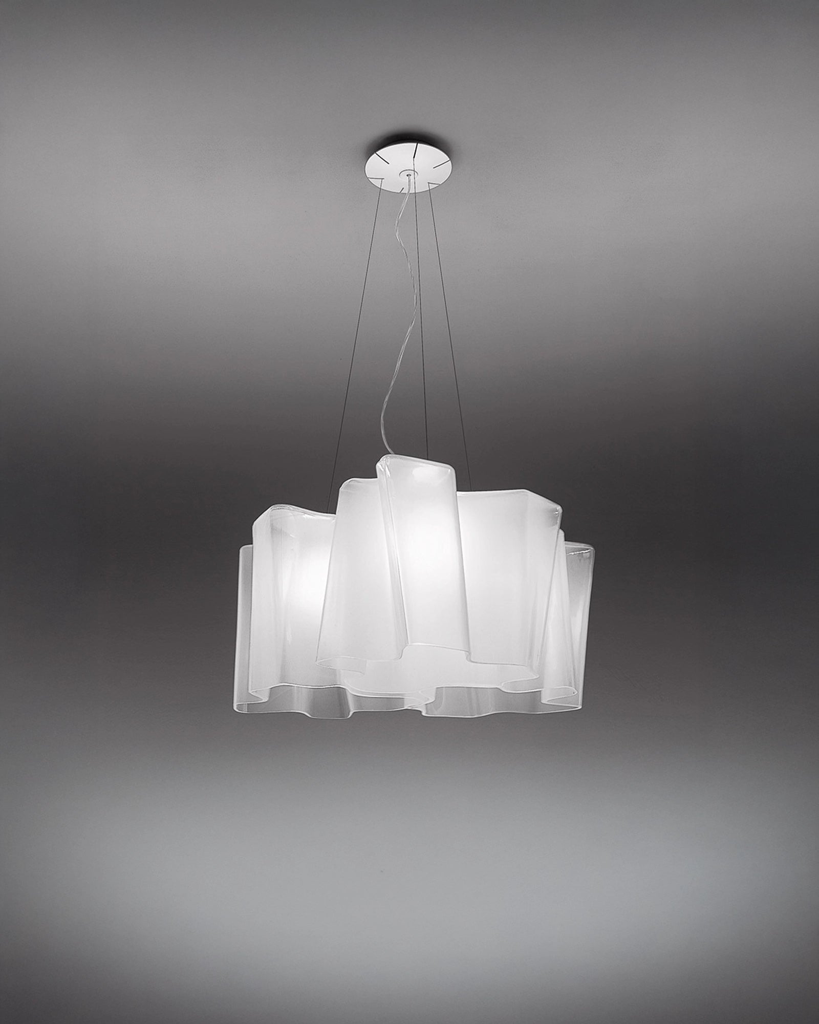 Modern pendant light with white blown glass shades on a gray background