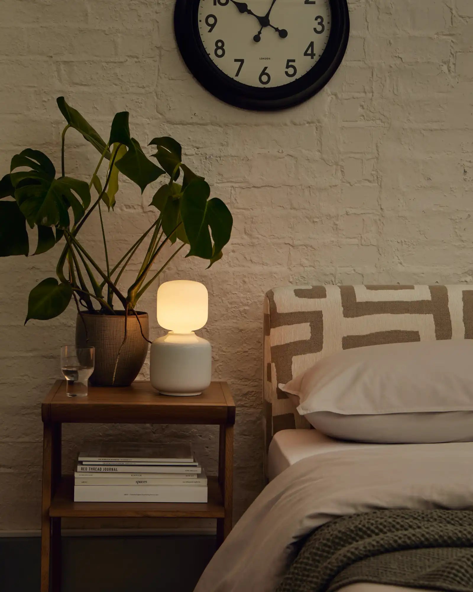 Oblo Reflection Table Lamp by Tala featured within a contemporary bedroom | Nook Collections
