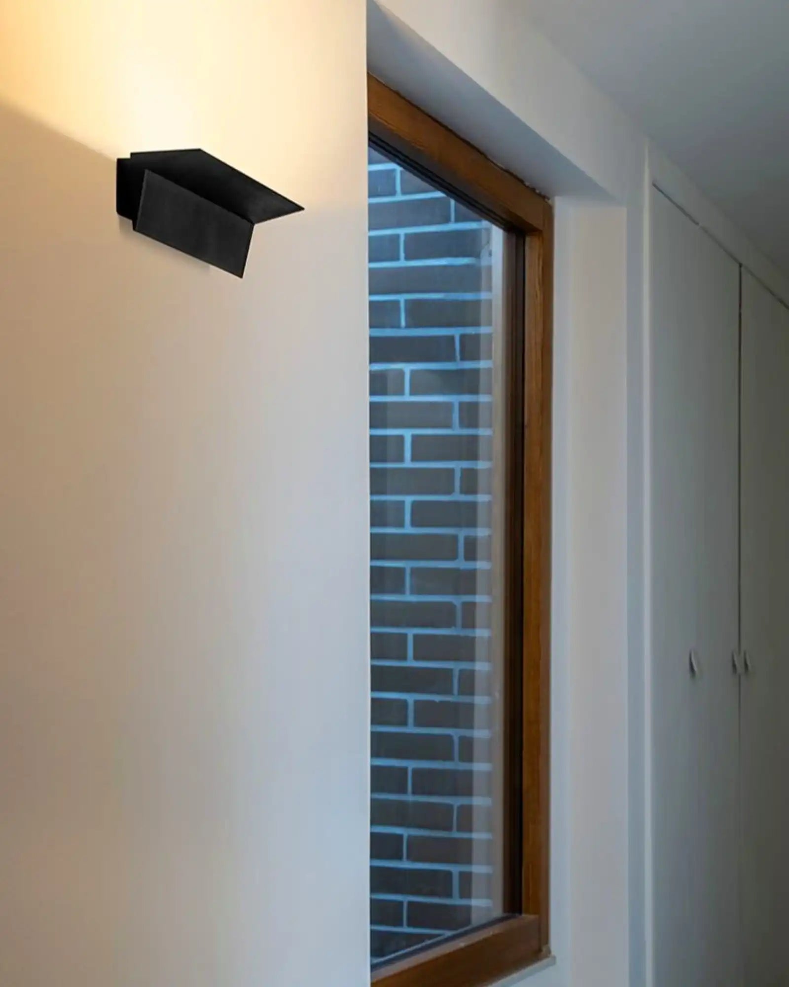 Zena Wall Light by Nemo Lighting featured in a hallway | Nook Collections
