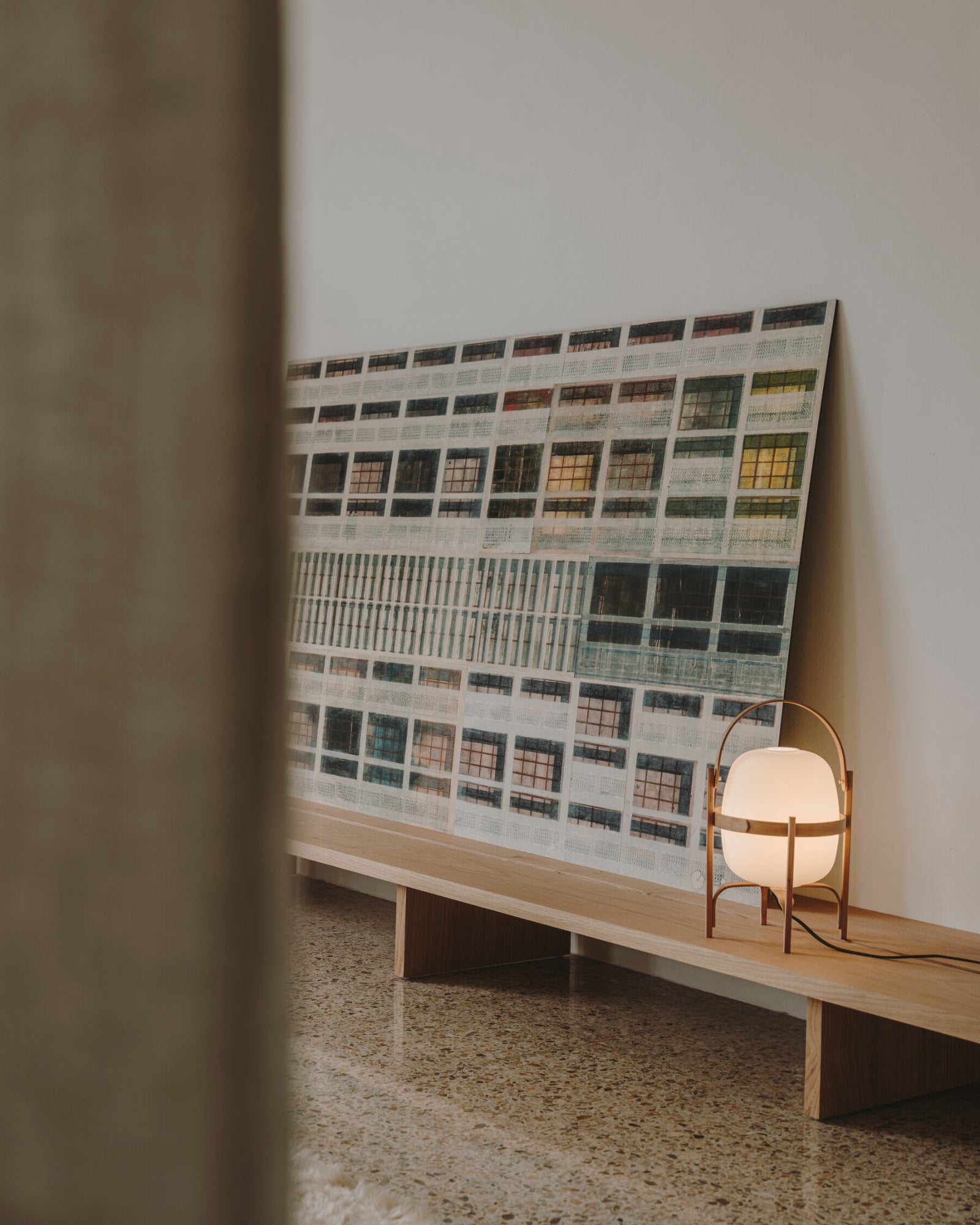 Contemporary table lamp called the Cestita Table Lamp in natural finish by Santa & Cole featured in a living room.