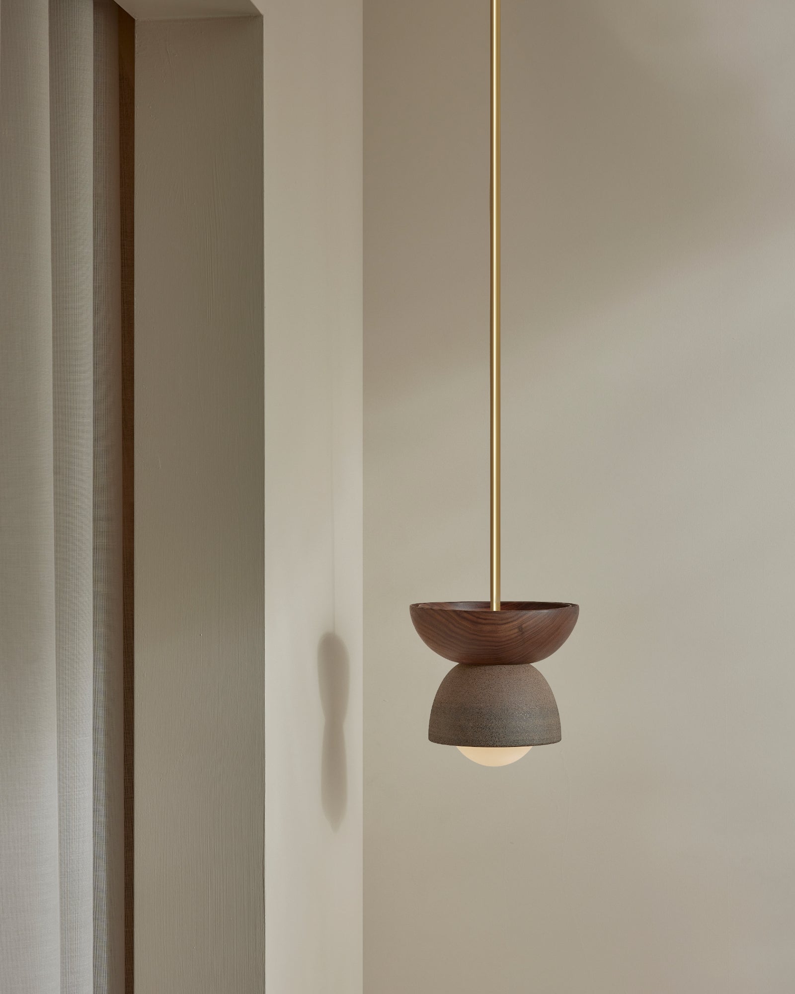 Terra 00 Rod Pendant Light with a walnut wood finish, clay ceramic finish, and a brass rod- Nook Collections
