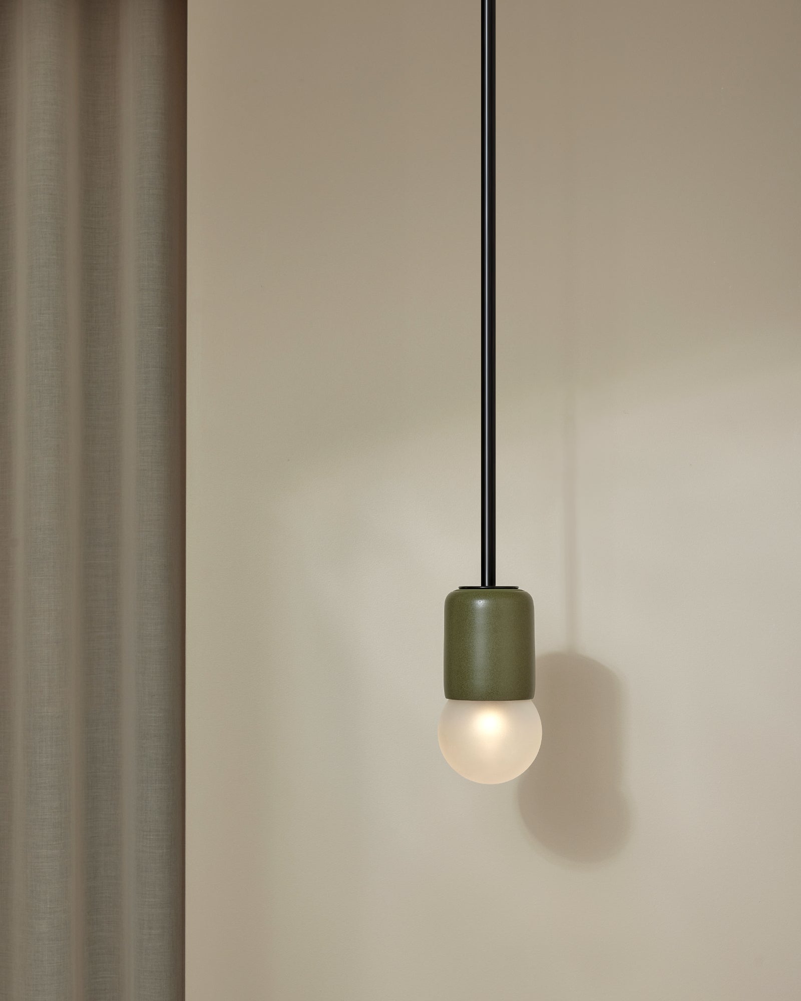 Terra 1 Pendant Light with Olive ceramic finish and brushed black rod. -Nook Collections