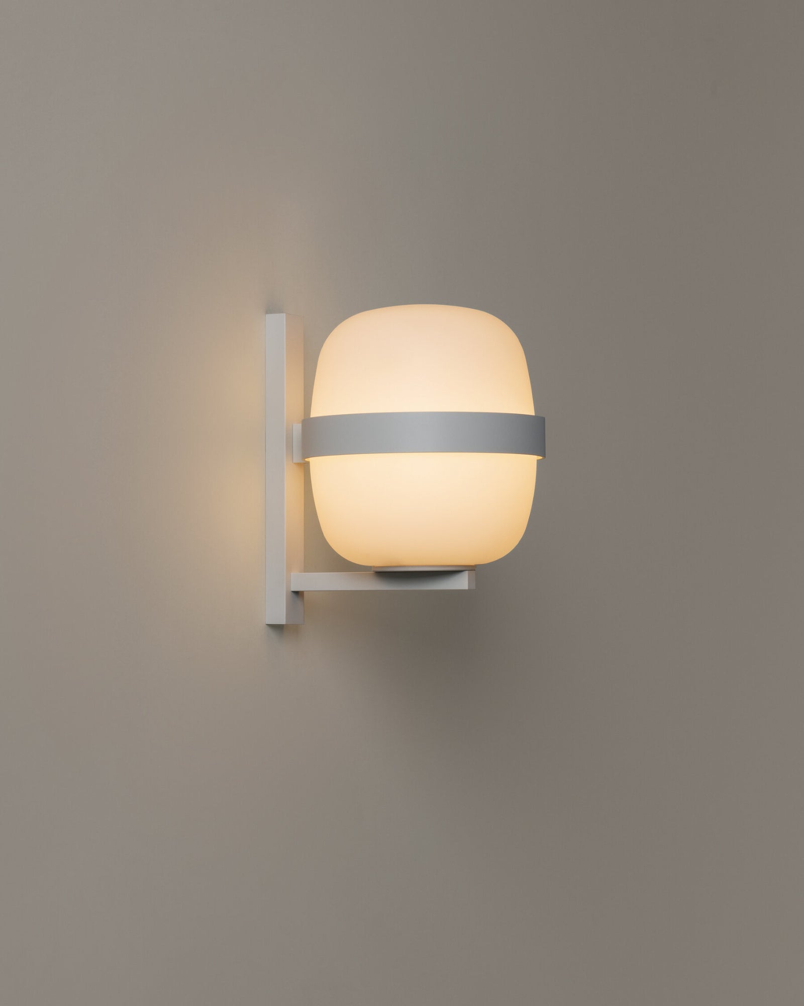 Contemporary white outdoor wall sconce with a globe-shaped opal glass diffuser.
