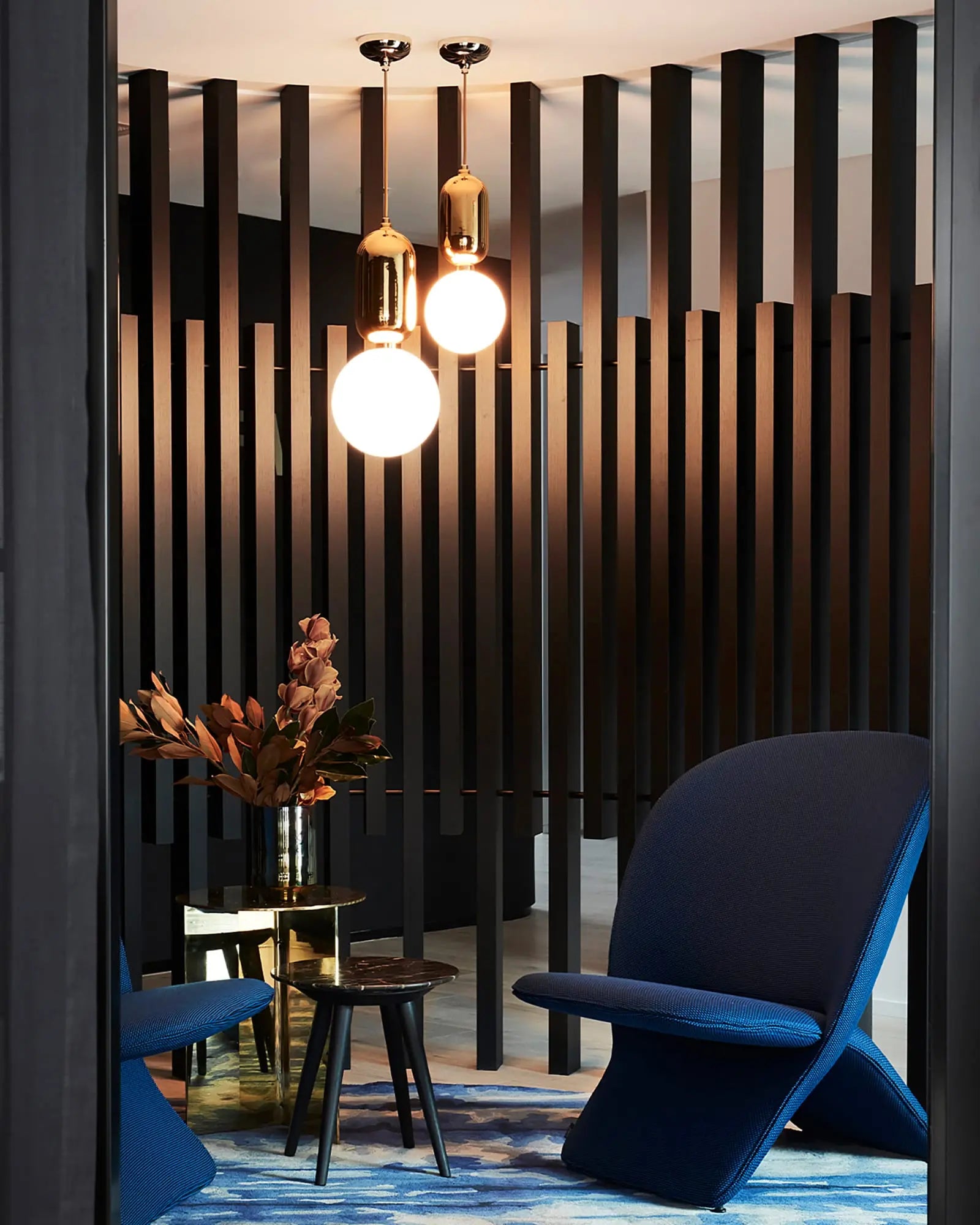 Aballs ceramic and orb blown glass shade pendant light above a coffe table in a lounge area