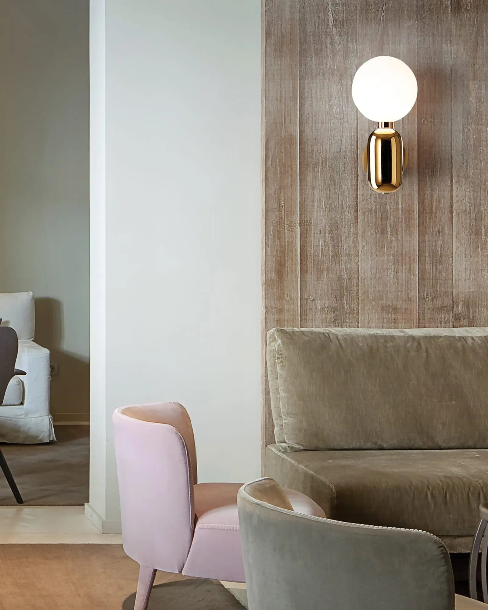 Aballs ceramic and blown glass orb wall lamp above a sofa