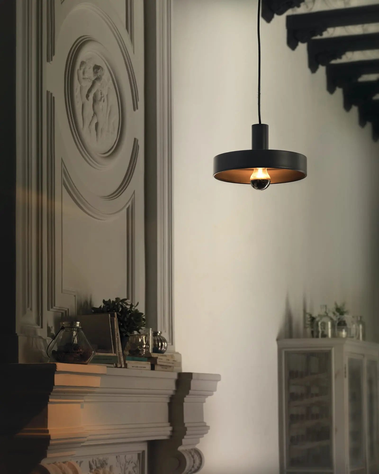 Aloa flat disc pendant light in a contemporary interior above a fireplace