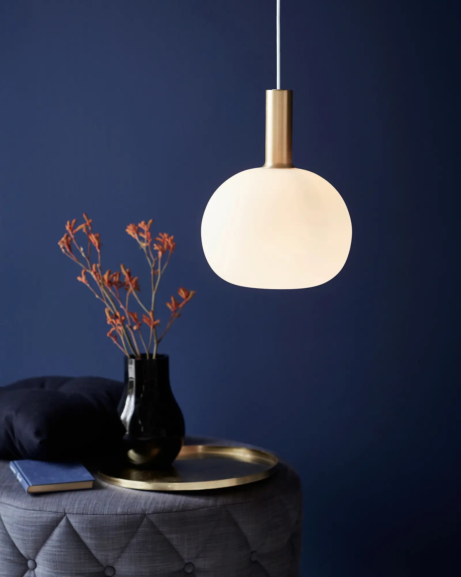 Alton Scandinavian Pendant light in blown glass opal and brass above a coffee table