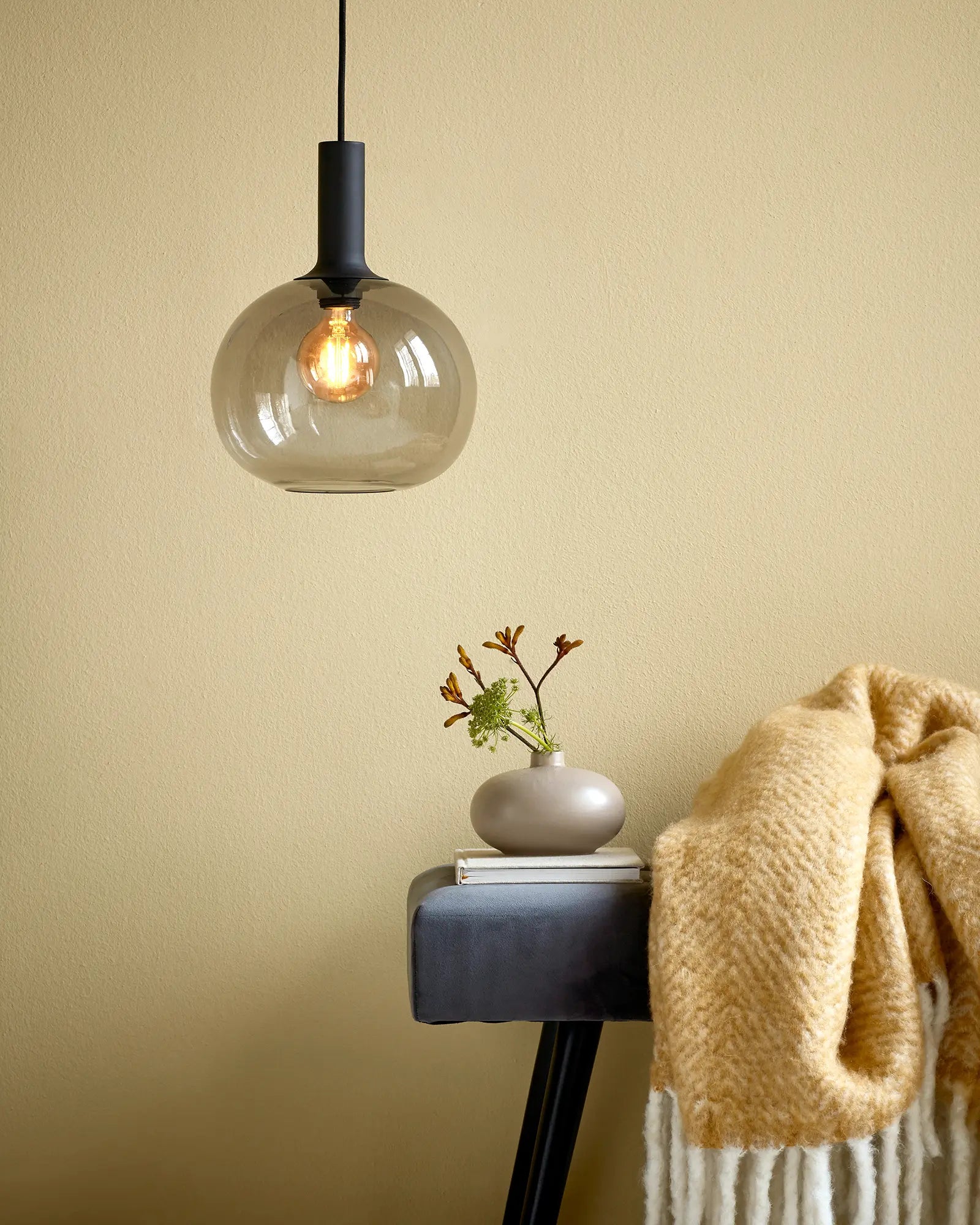Alton Scandinavian Pendant light in blown glass  smoke and black above a seat