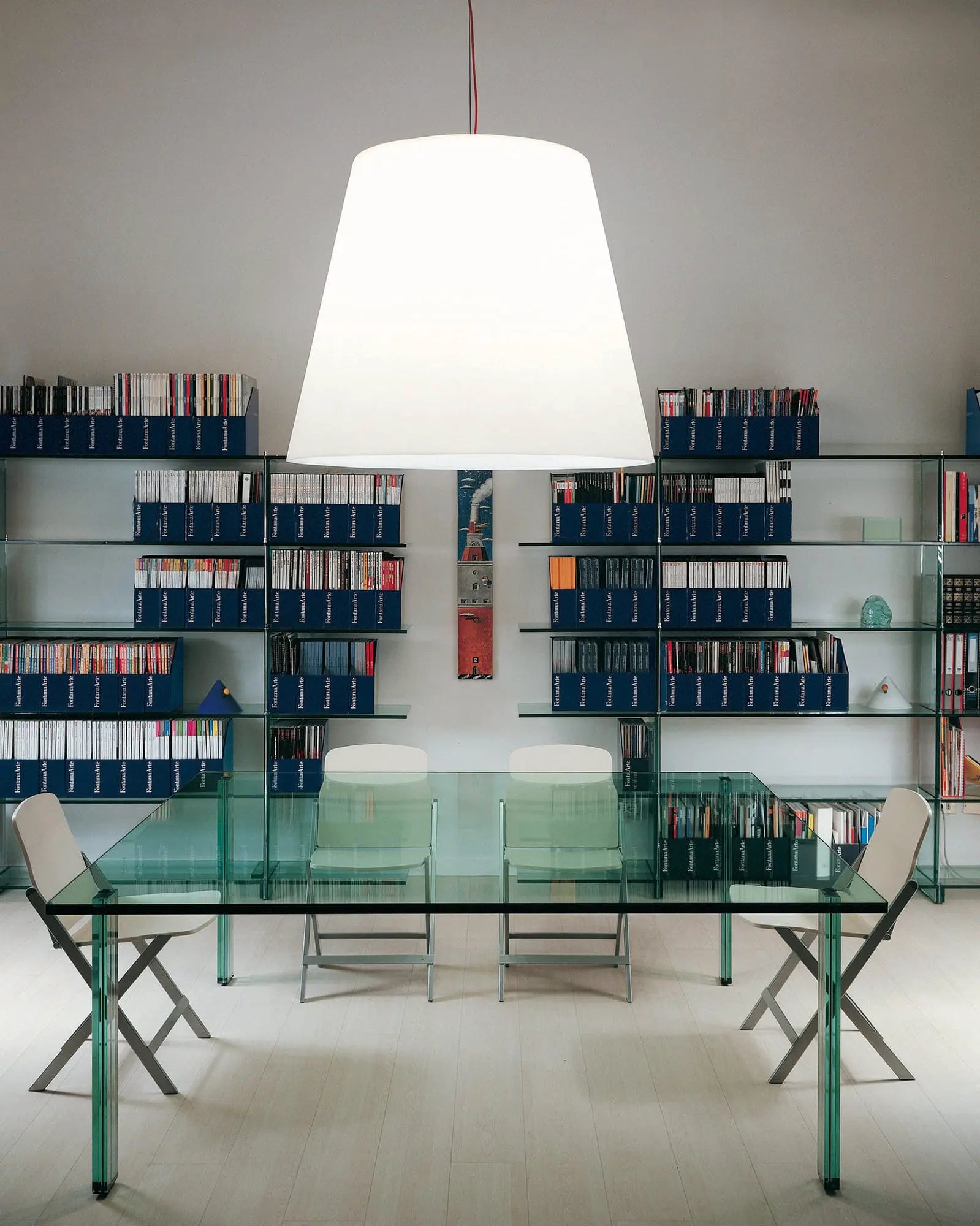 Amax Iconing Pendant light etched glass above a glass dining table