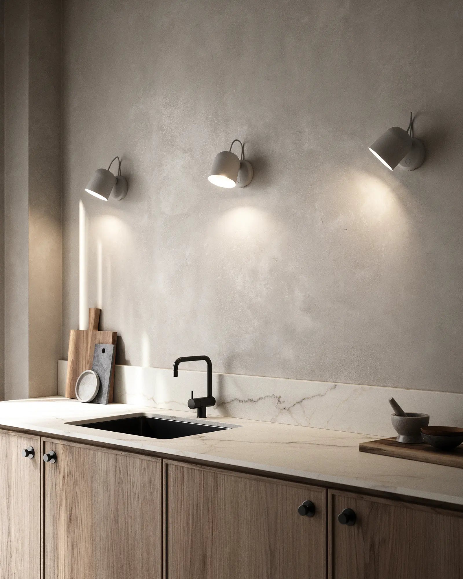 Angle adjustable Scandinavian wall light above a kitchen bench