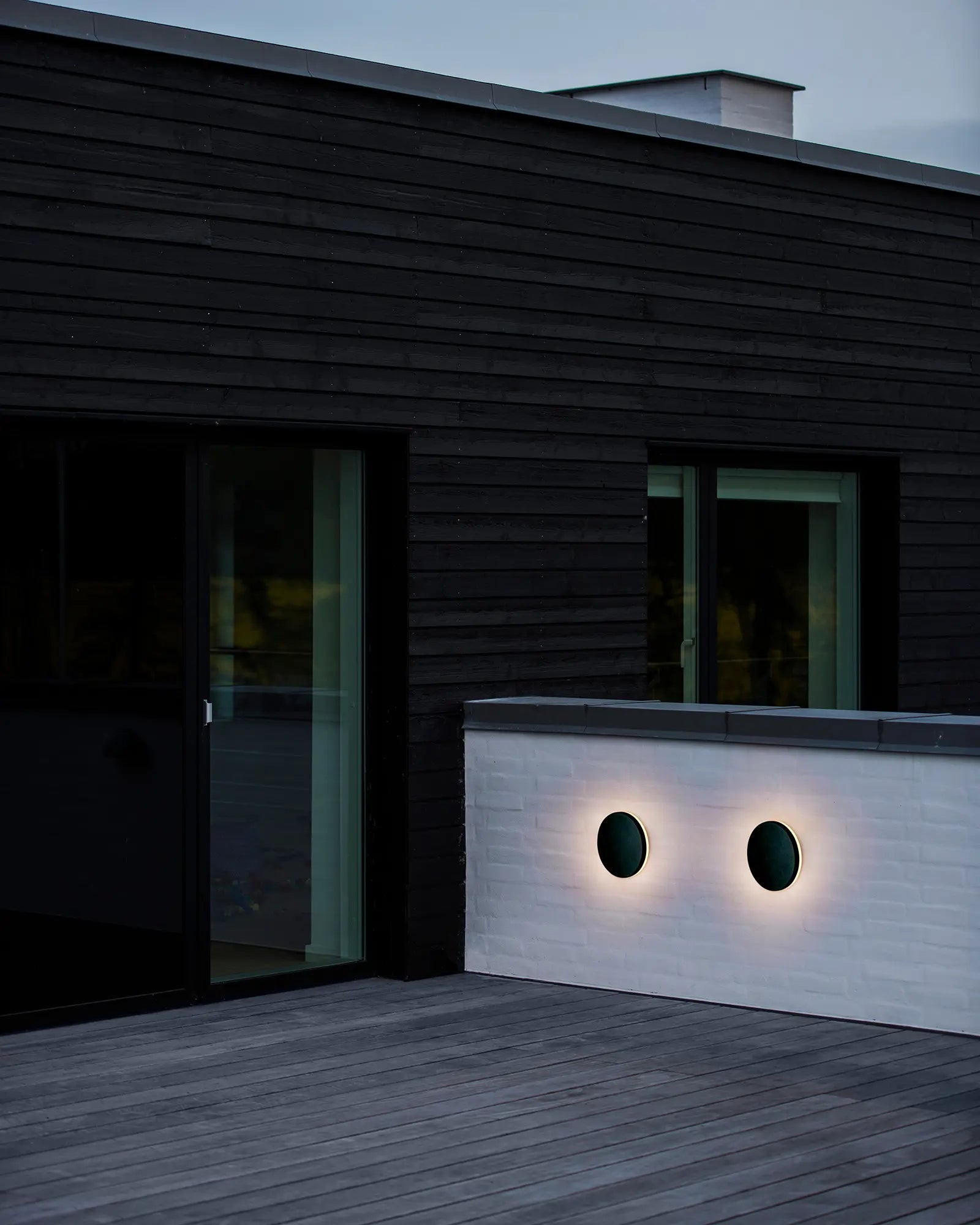 Artego Round minimal outdoor wall light on cladded exterior wall