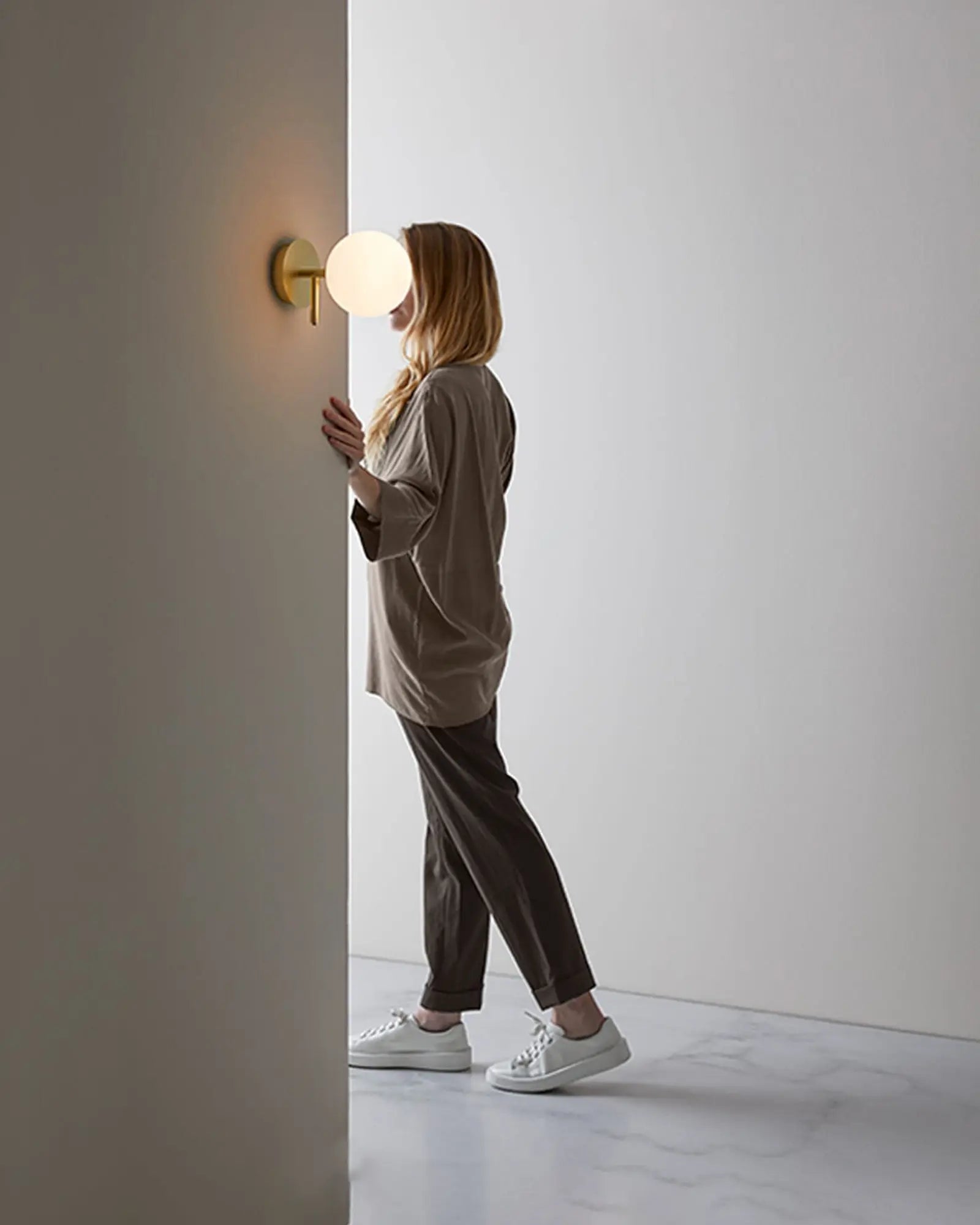 Atom Contemporary orb opal glass shade wall light in a hallway