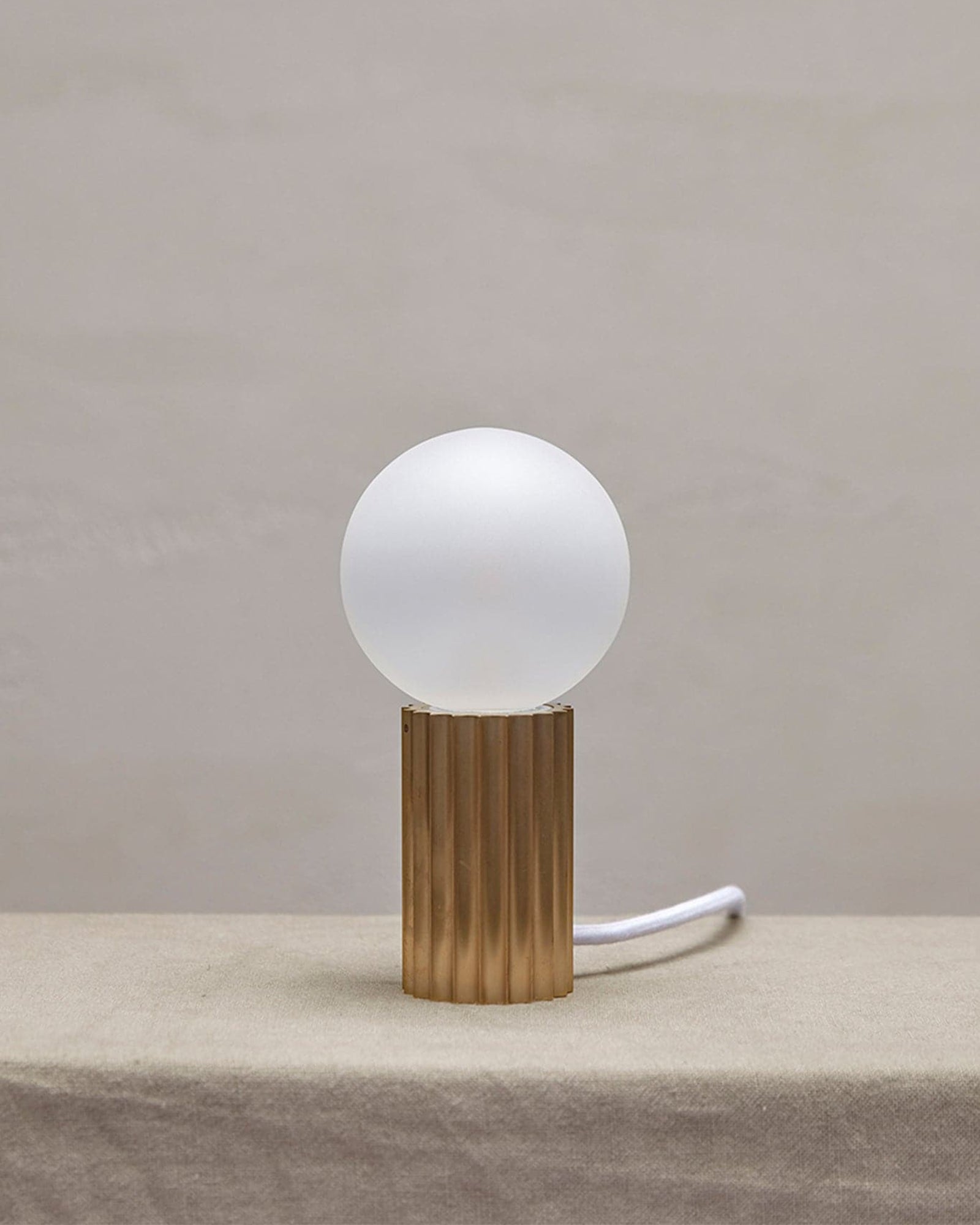 Attalos brass and glass table lamp on a table