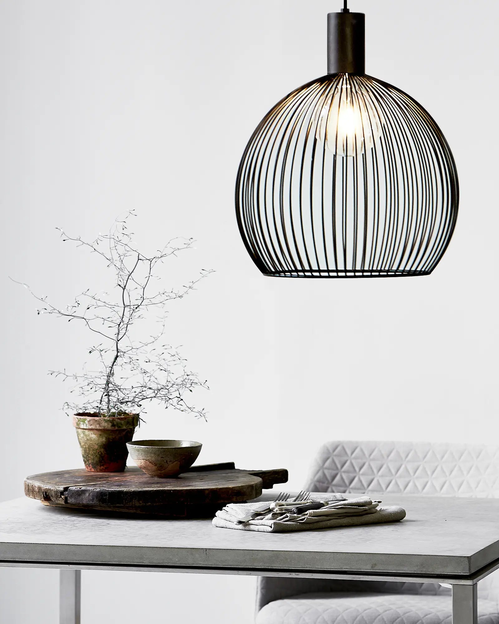Aver bird cage Scandinavian pendant light 40cm above a dining table