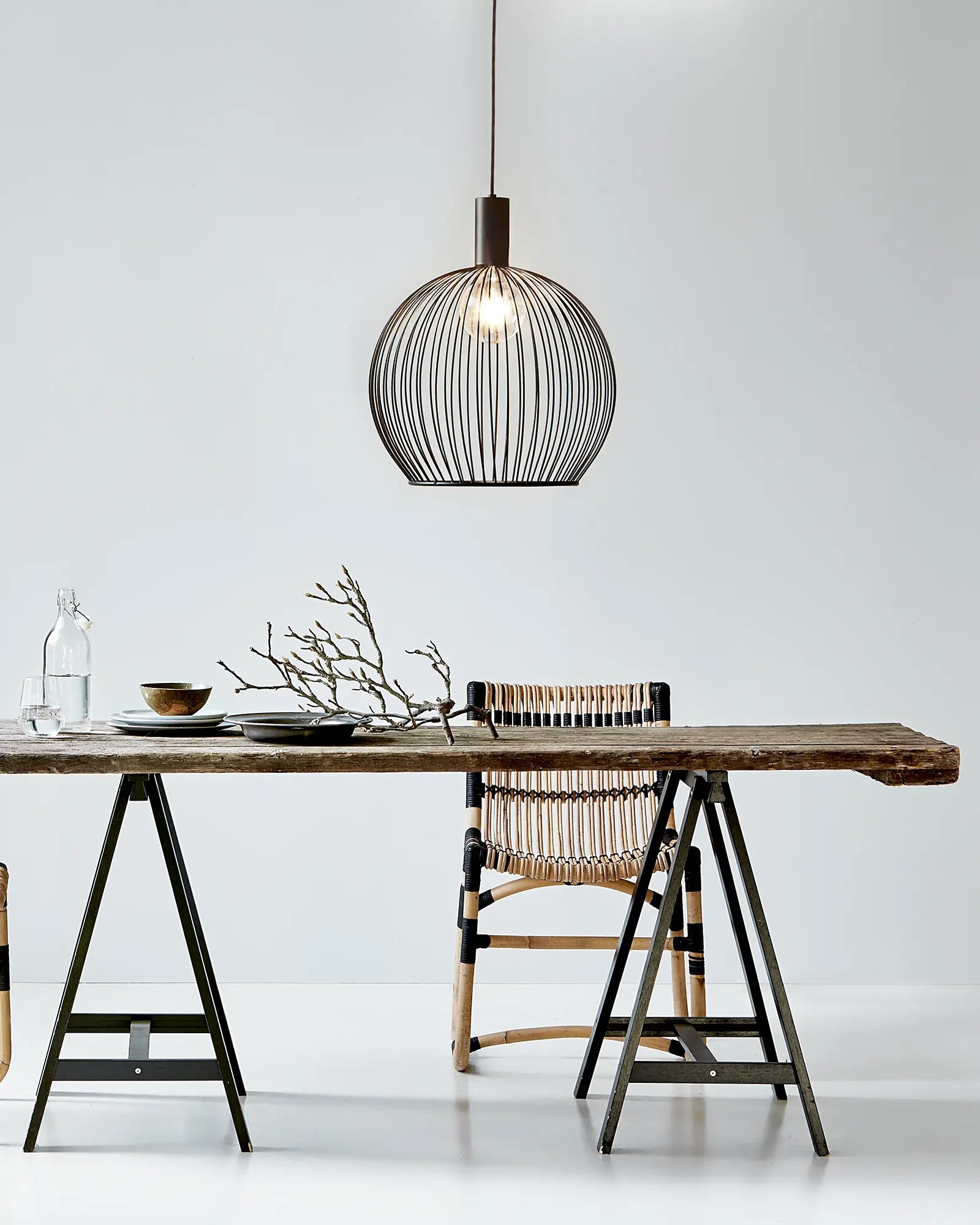 Aver bird cage Scandinavian pendant light 50cm above a dining table