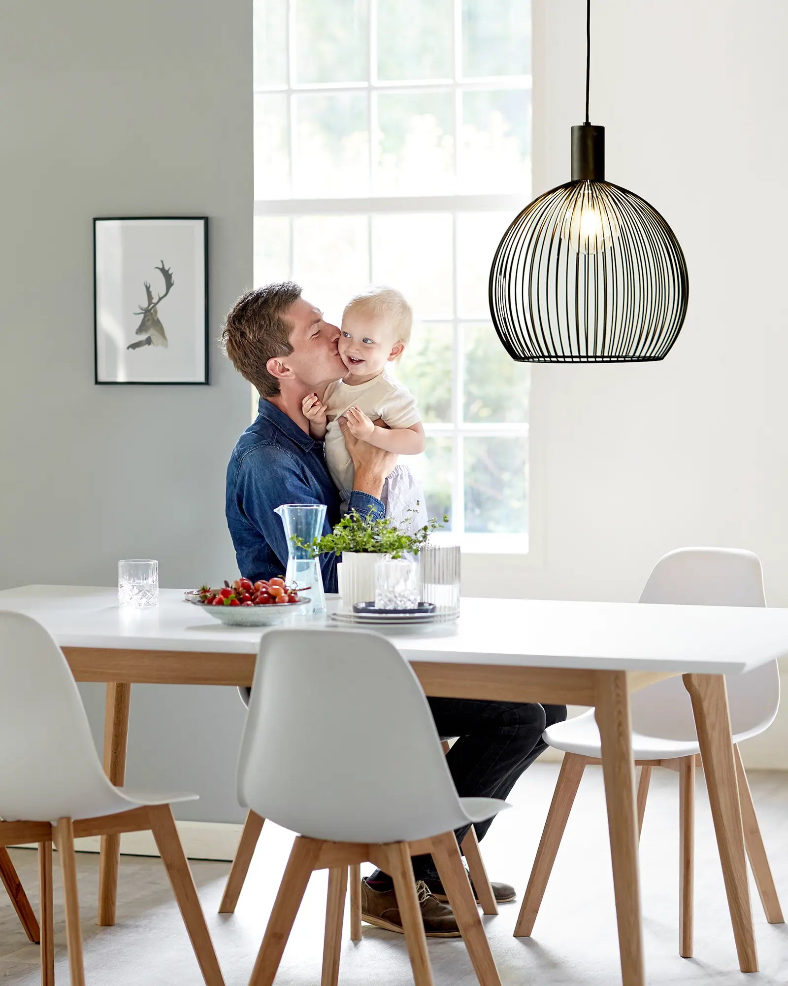 Aver bird cage Scandinavian pendant light 50cm above a dining table