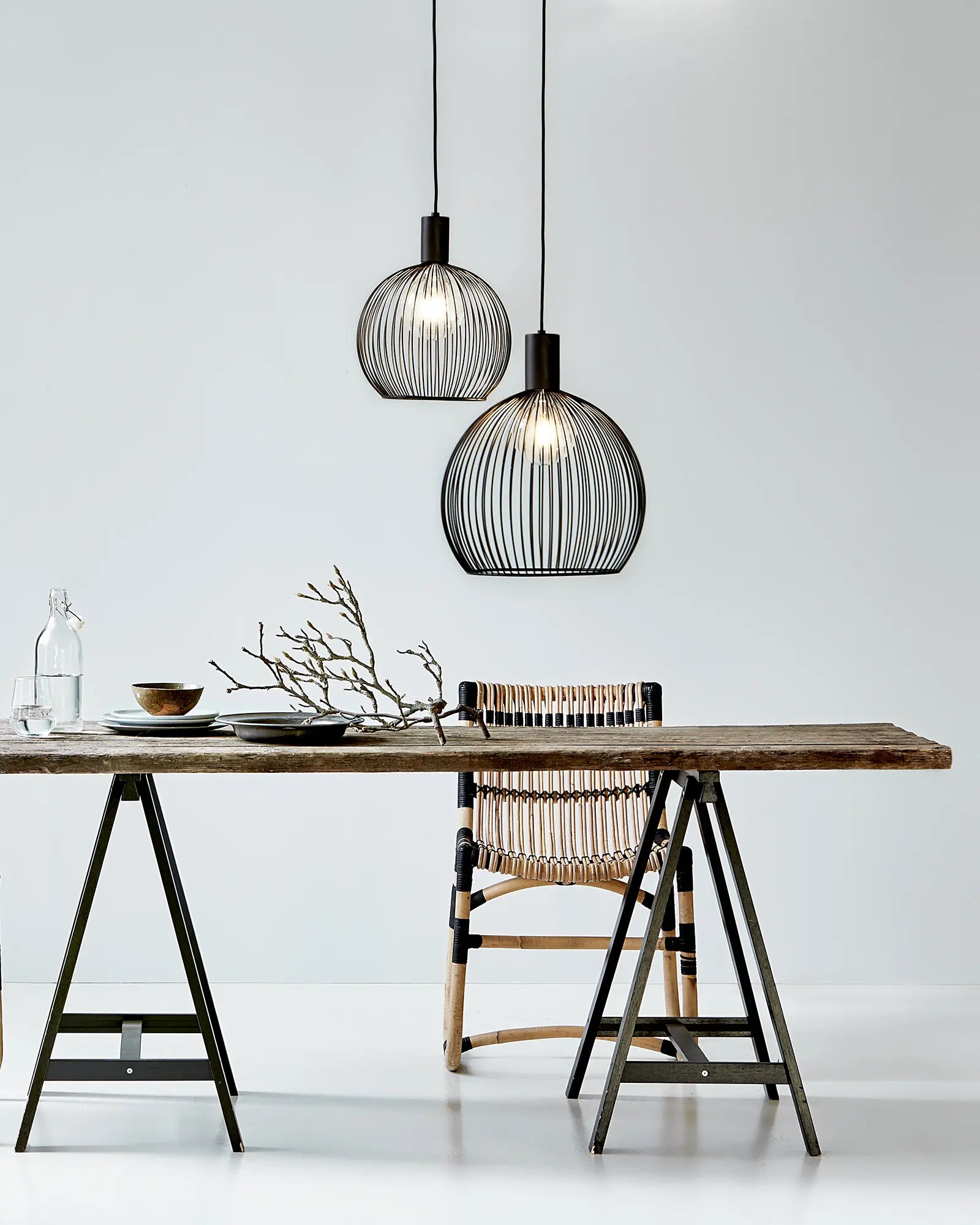 Aver bird cage Scandinavian pendant light cluster above a dining table