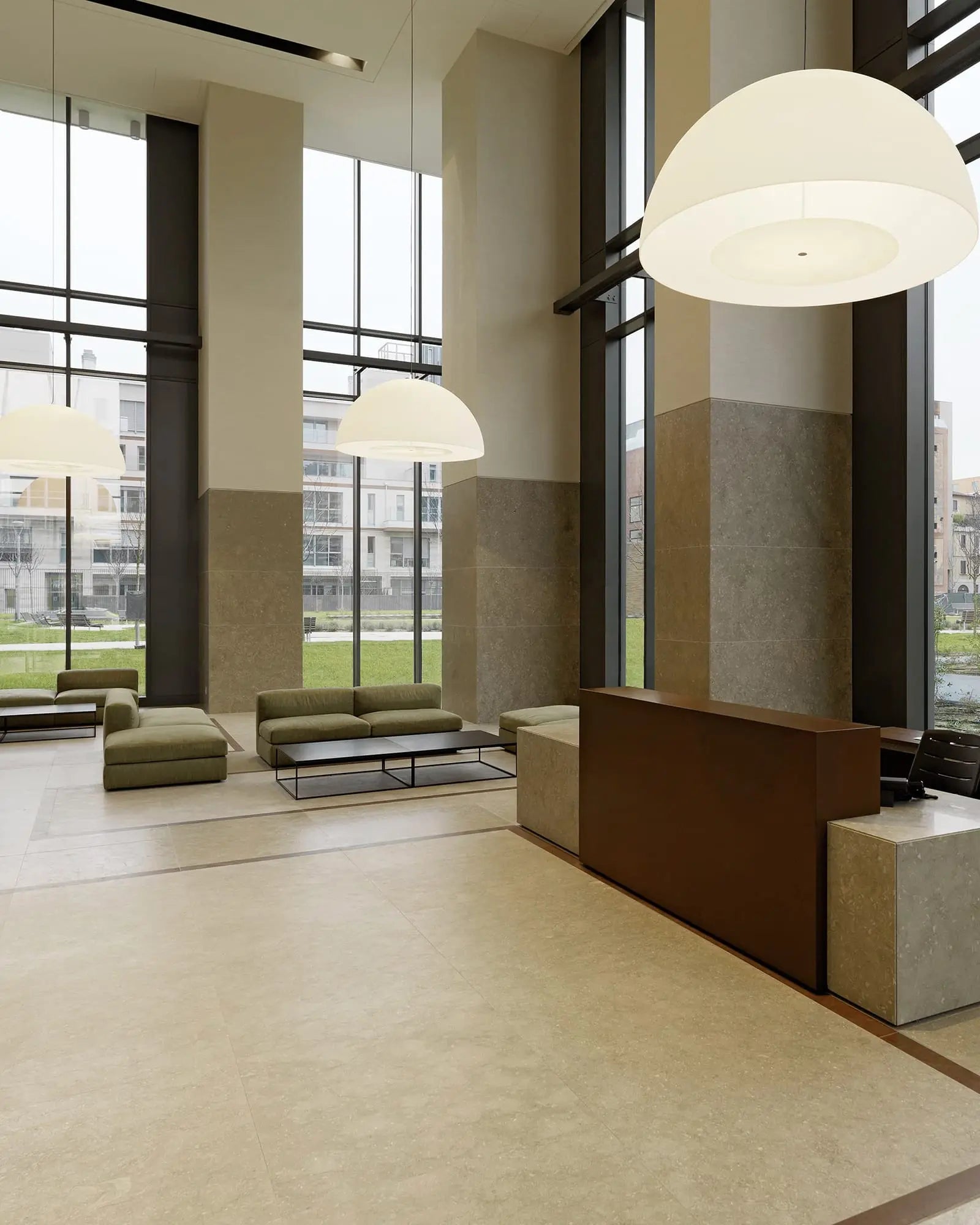 Avico large dome pendant above a reception and sofa