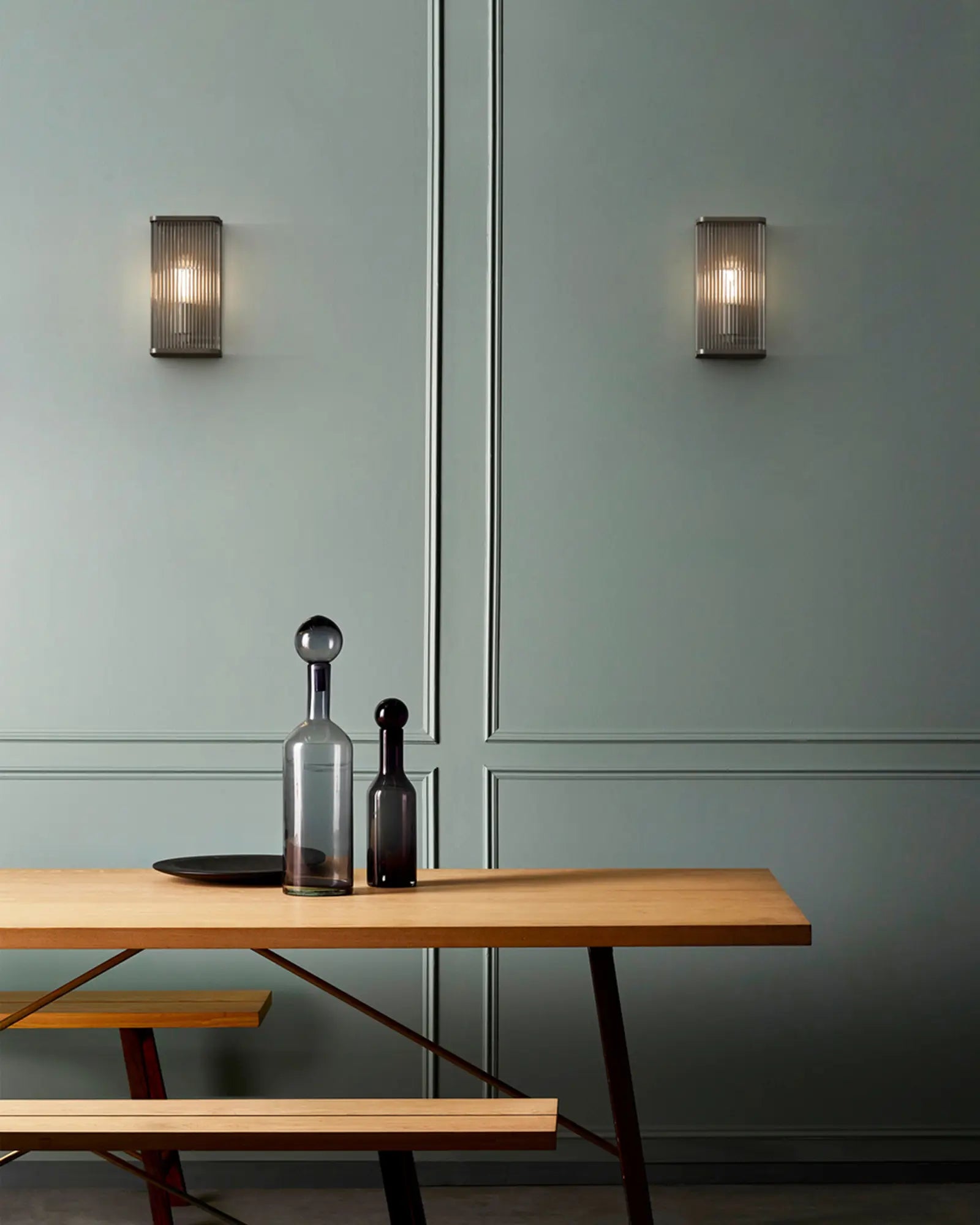 Avignon square wall light in bronze small above a table in a cafe