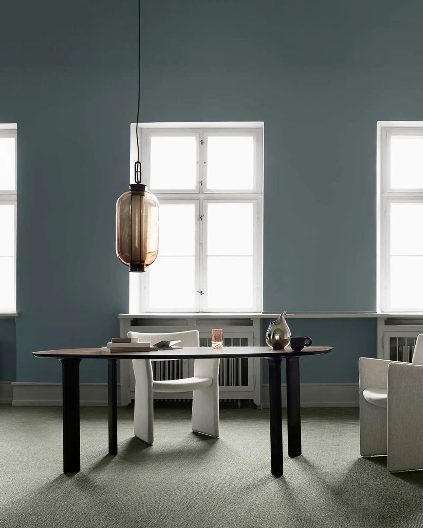 Bai Ba Ba tall bronze and blown glass Chinese lantern style pendant light above a table