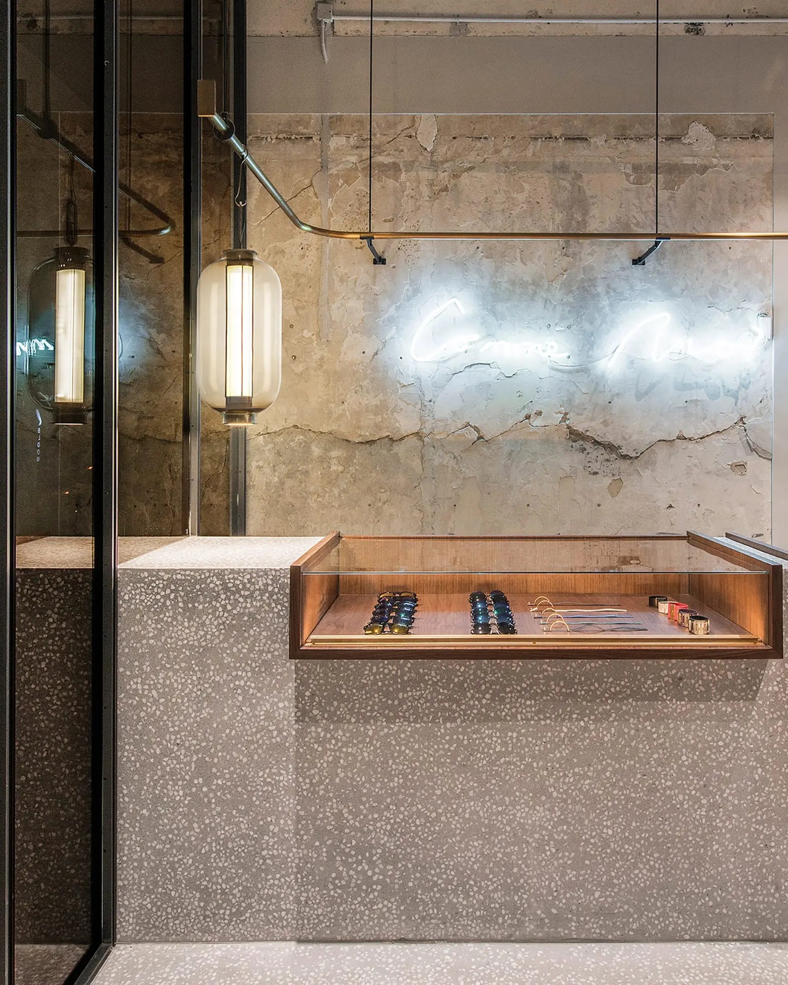 Bai Ba Ba tall bronze and blown glass Chinese lantern style pendant light above a display commercial project