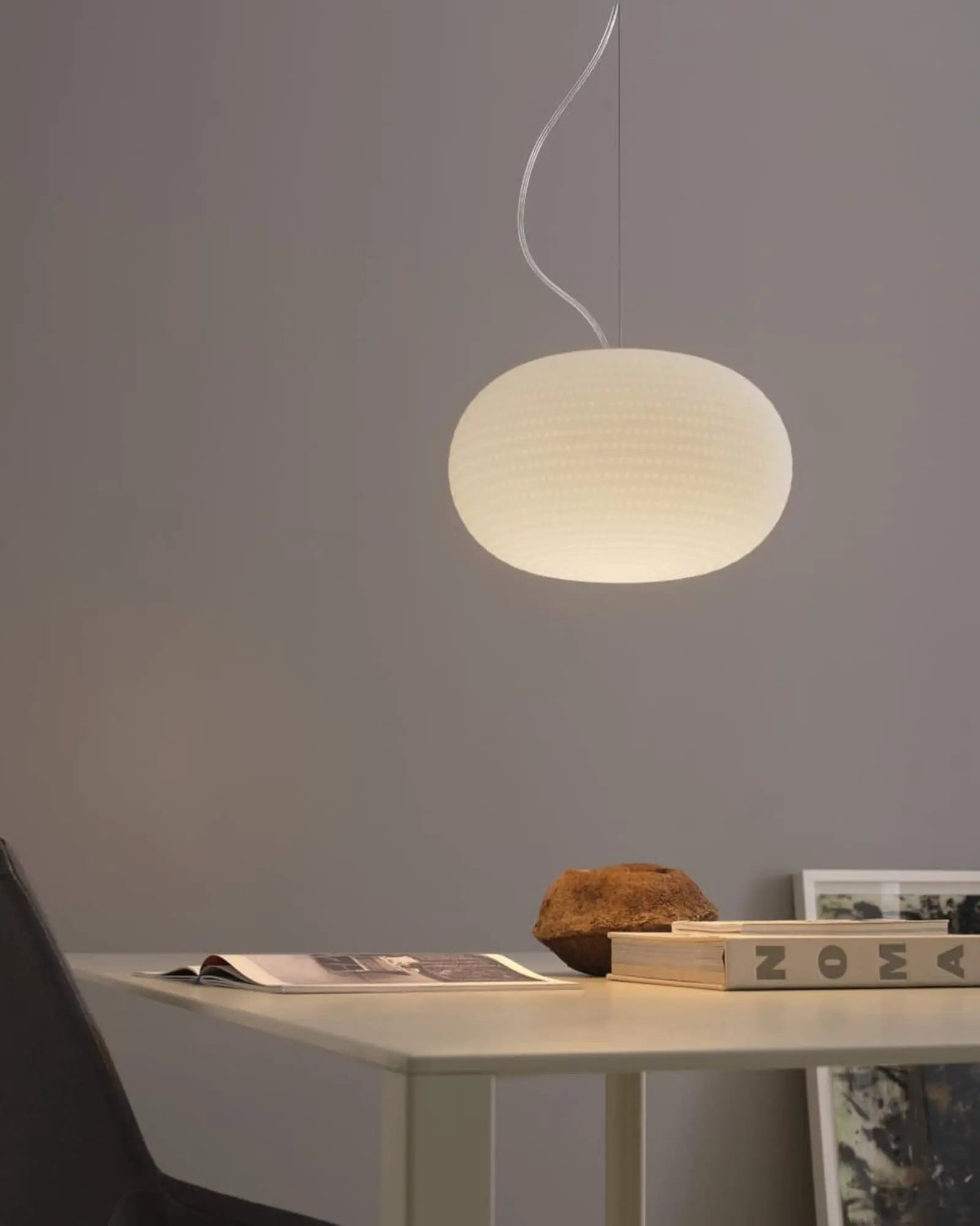 Bianca orb blown glass pendant light above a desk
