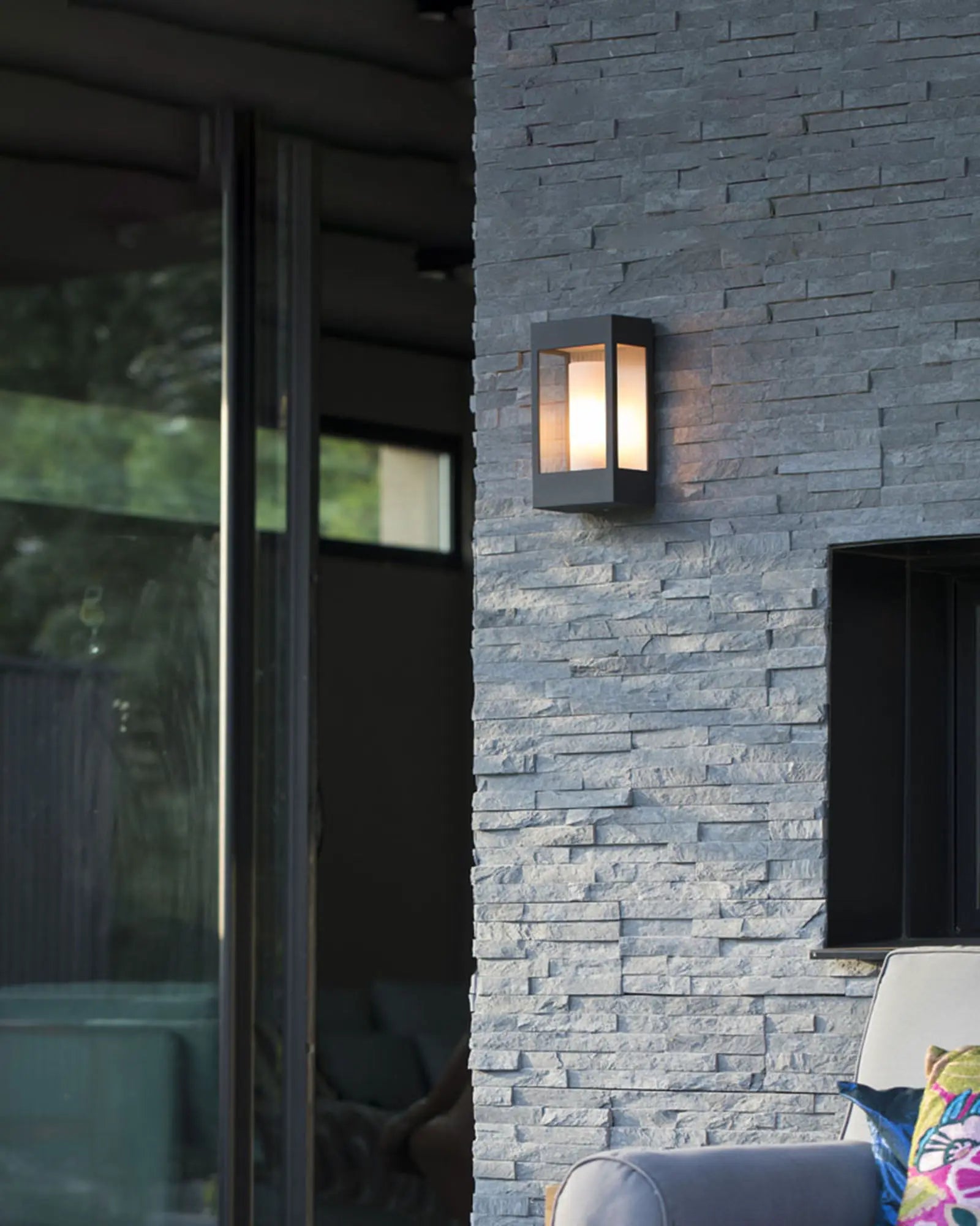 Brick outdoor wall light above an exterior entertainment area