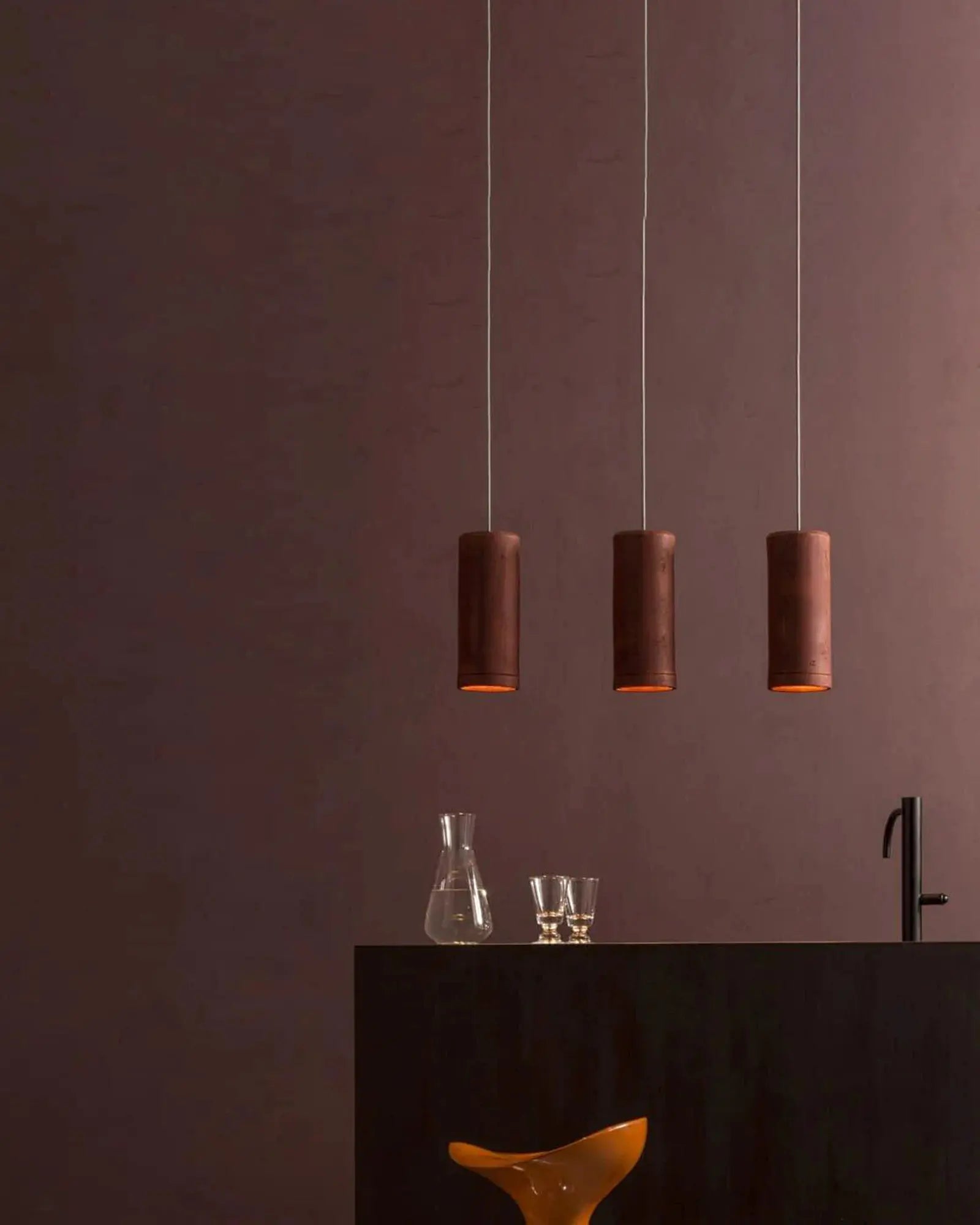 Carso minimalistic terracotta pendant light cluster over a kitchen island