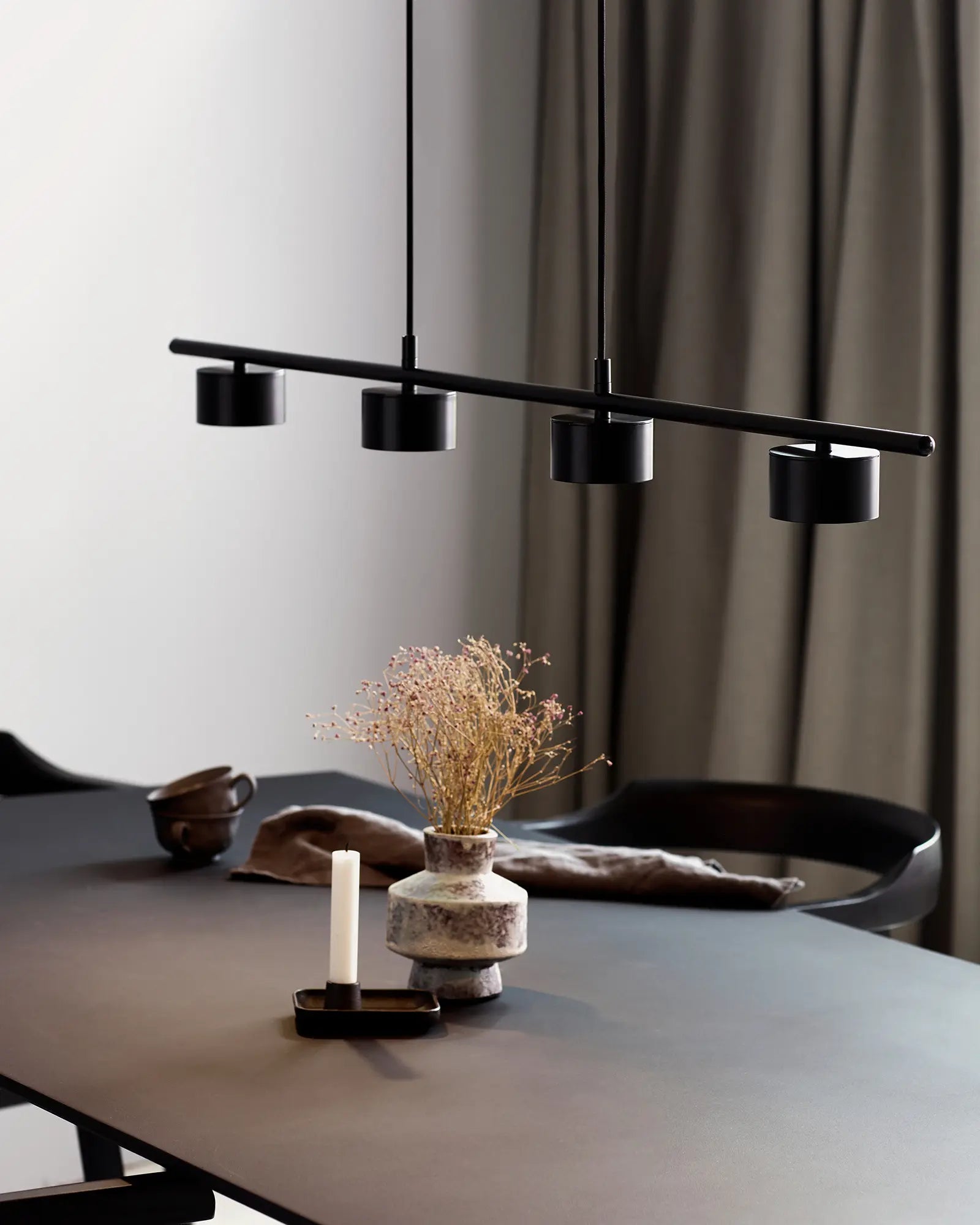 Linear Scandinavian pendant light above dining table