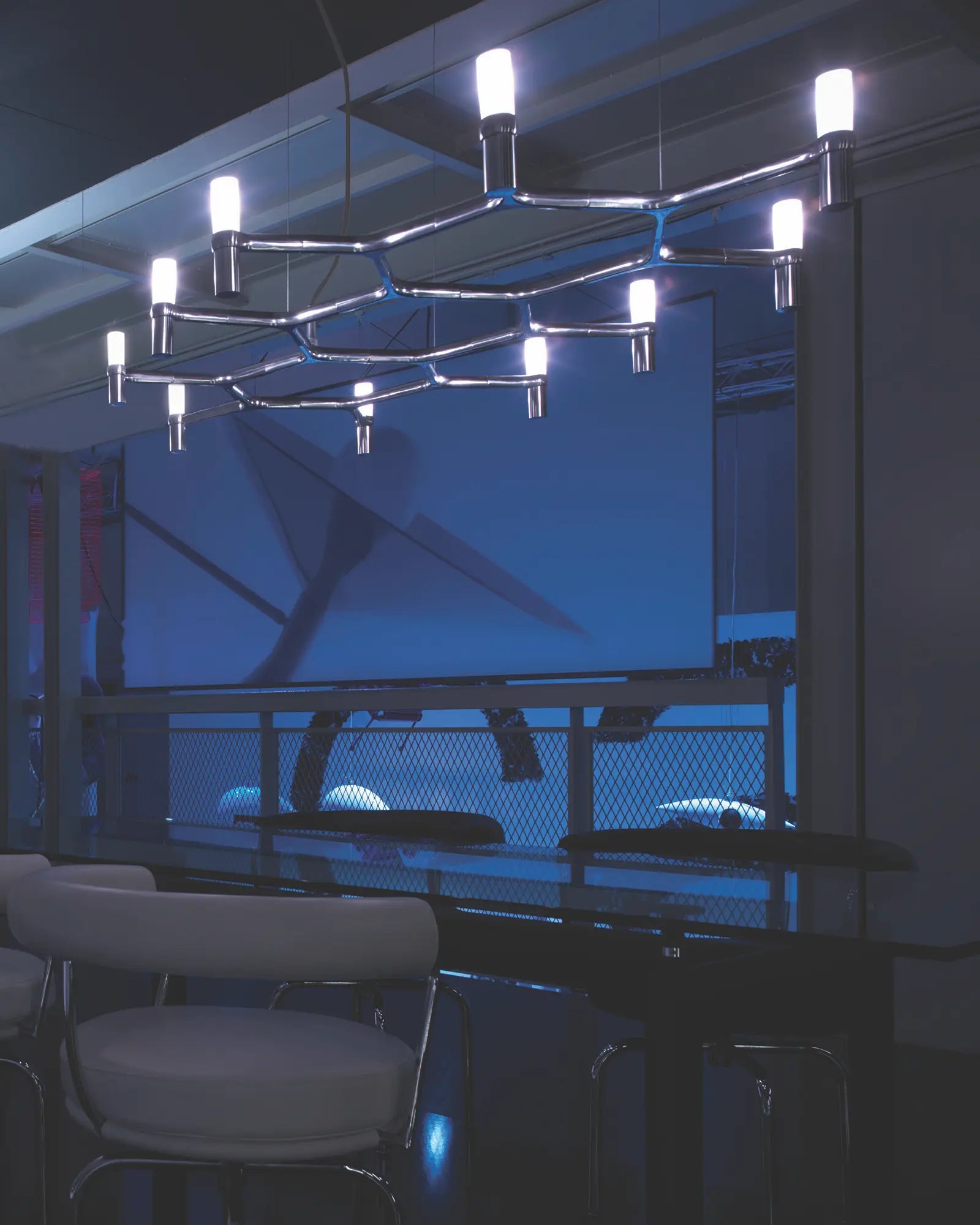 Crown plana long horizontal pendant light above a table