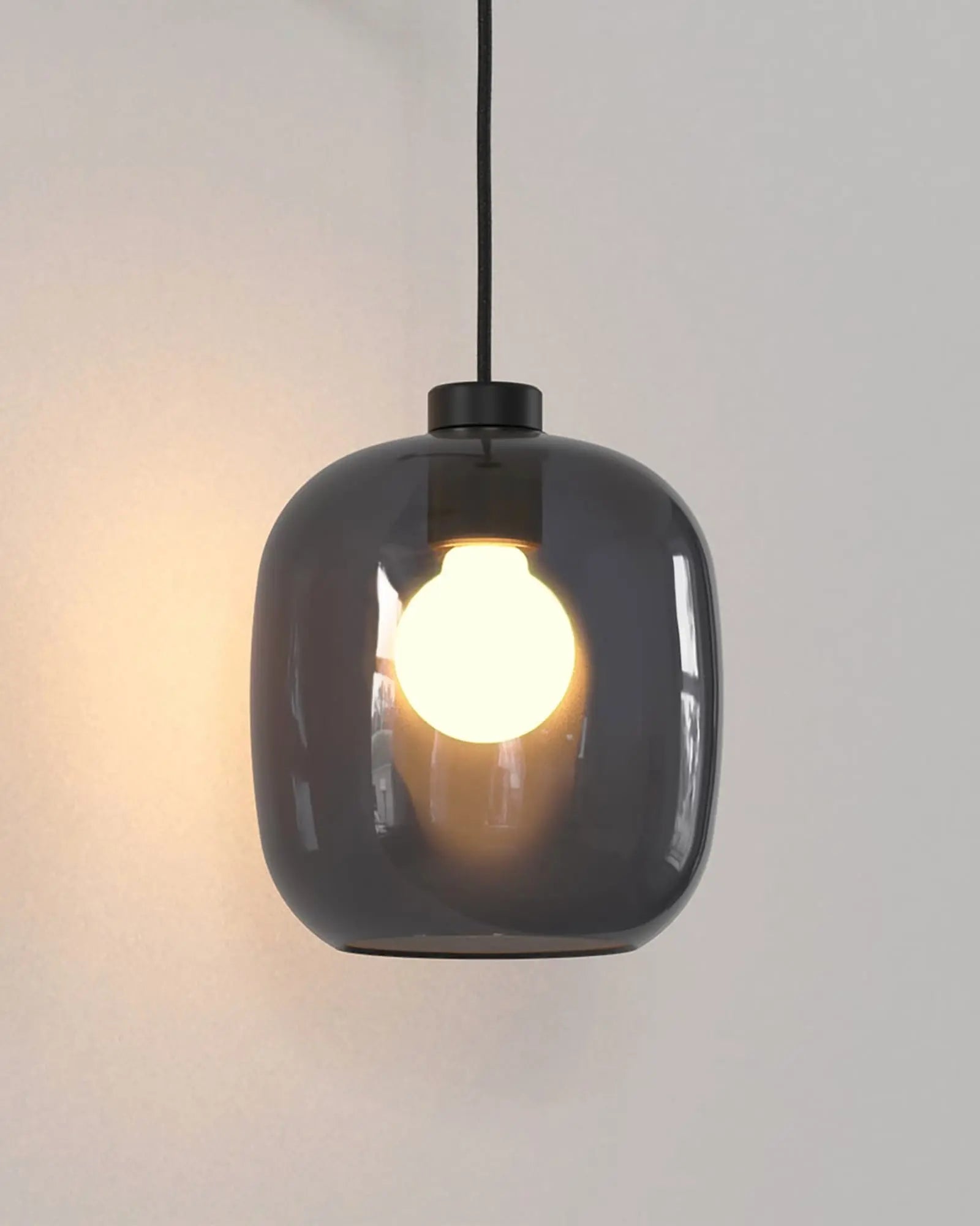 Curve contemporary pendant light with wall mount and smoke blown glass shade glass detail