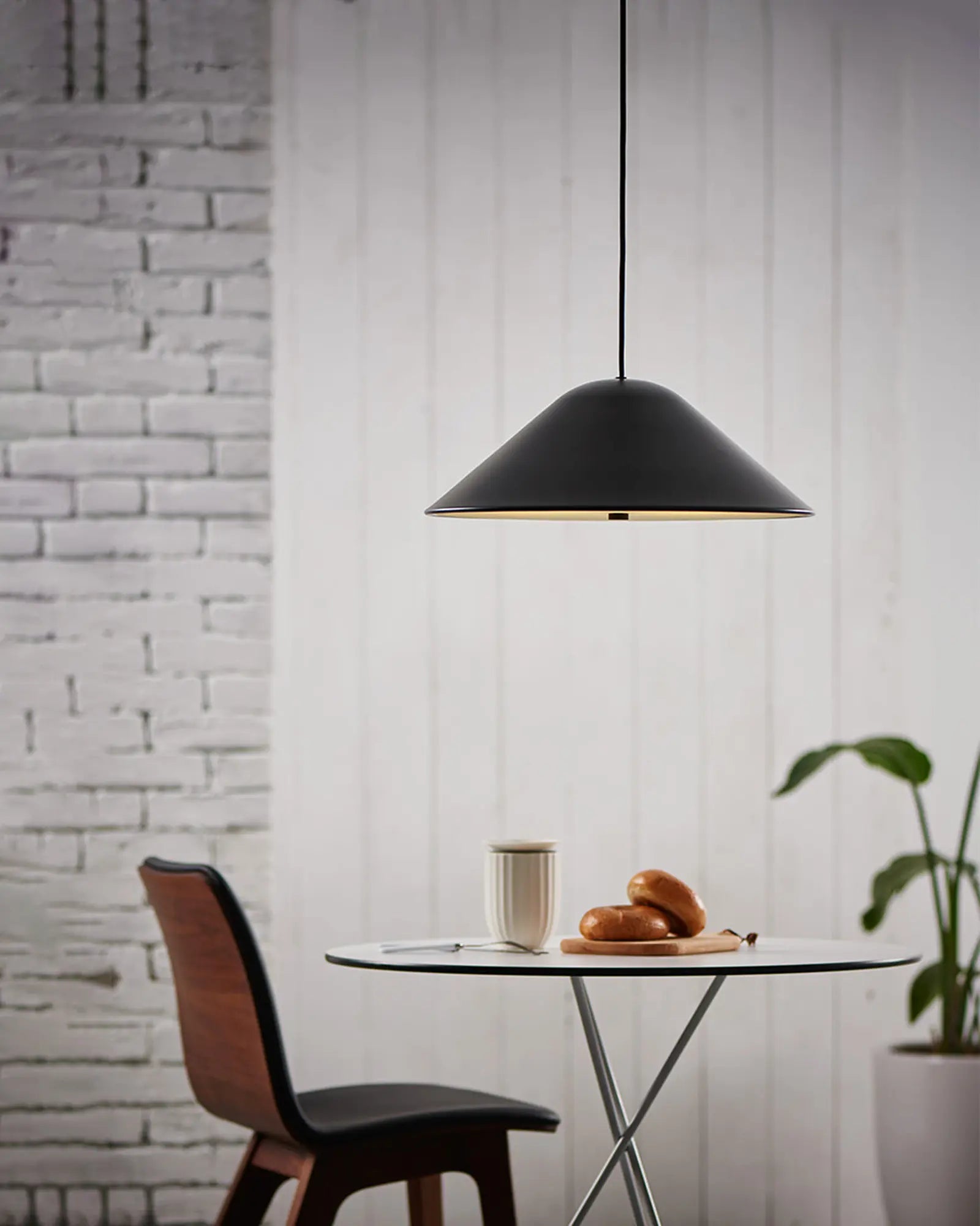 Damo contemporary dome pendant light above a round table