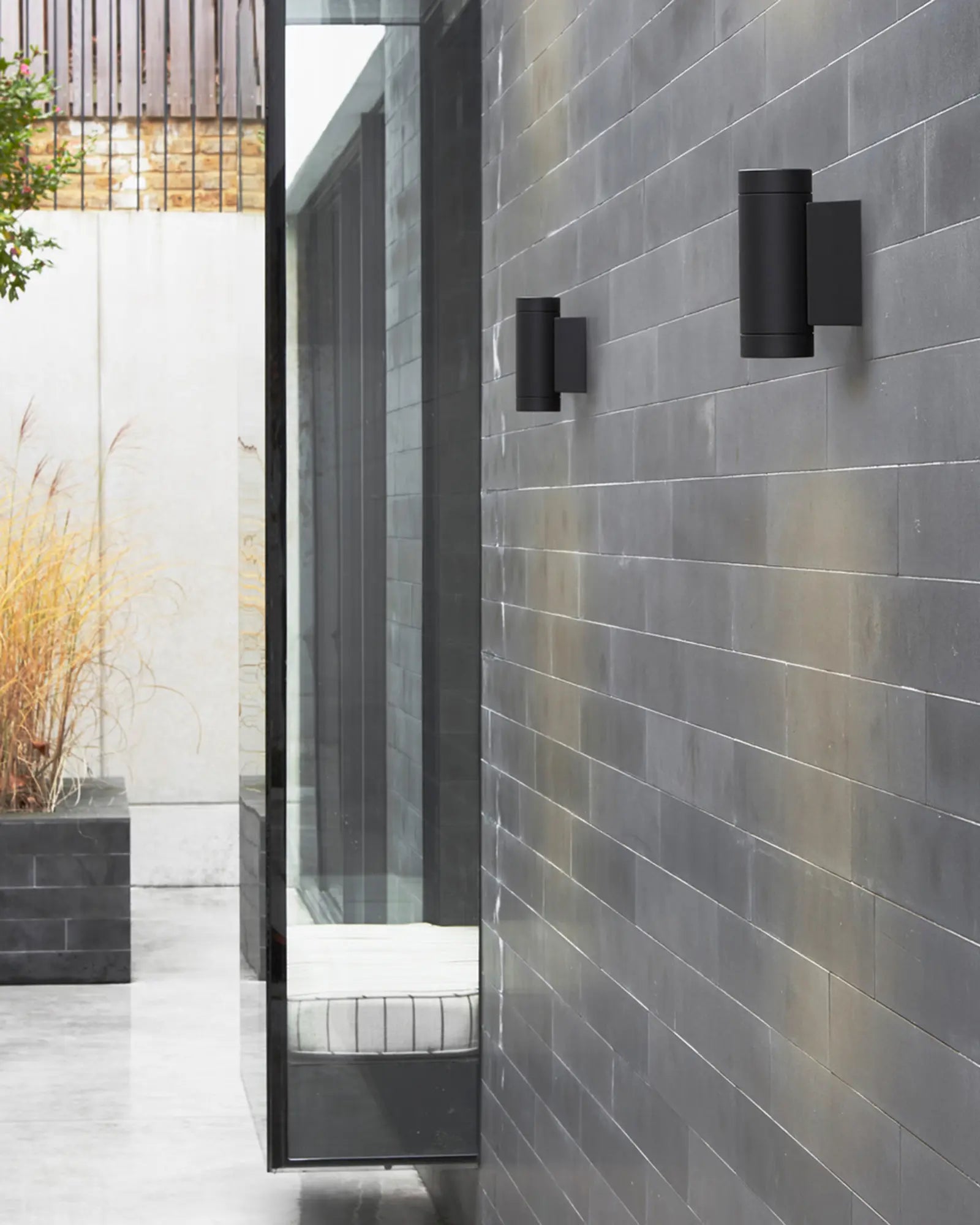 Darthmouth up and down outdoor wall light in a backyard
