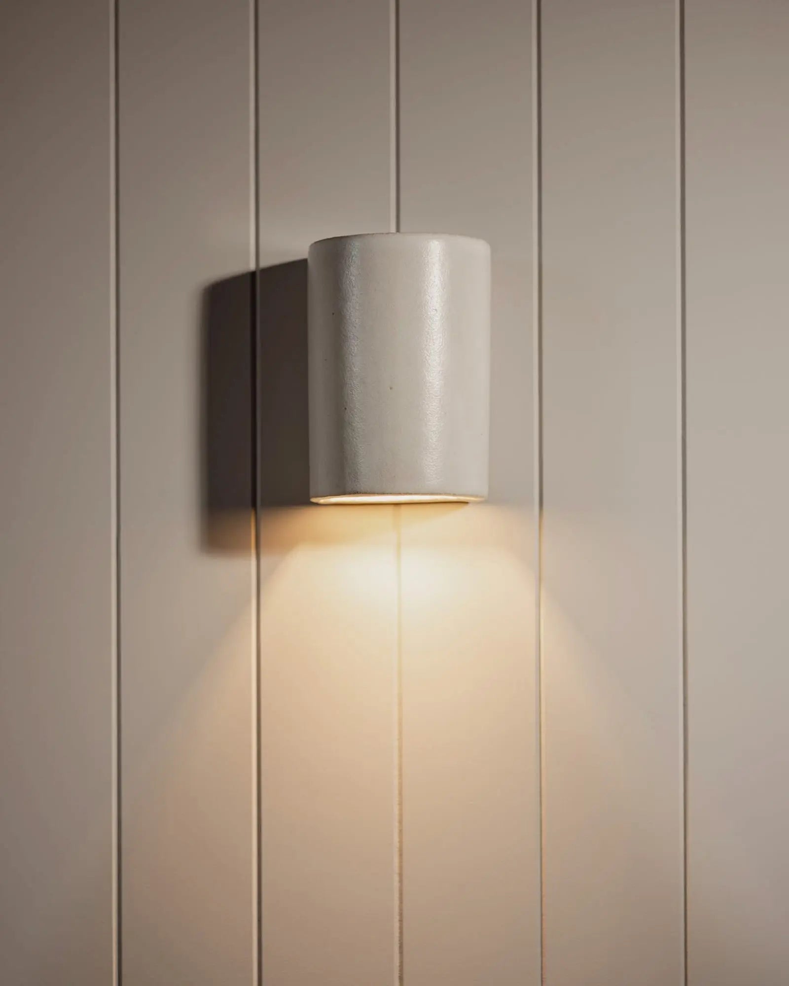 Dawn Ceramic outdoor wall light on cladded wall