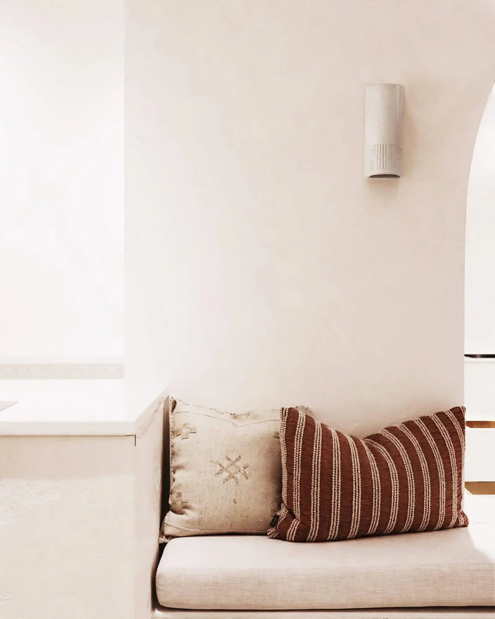 Day ceramic hand made wall light above a lounge