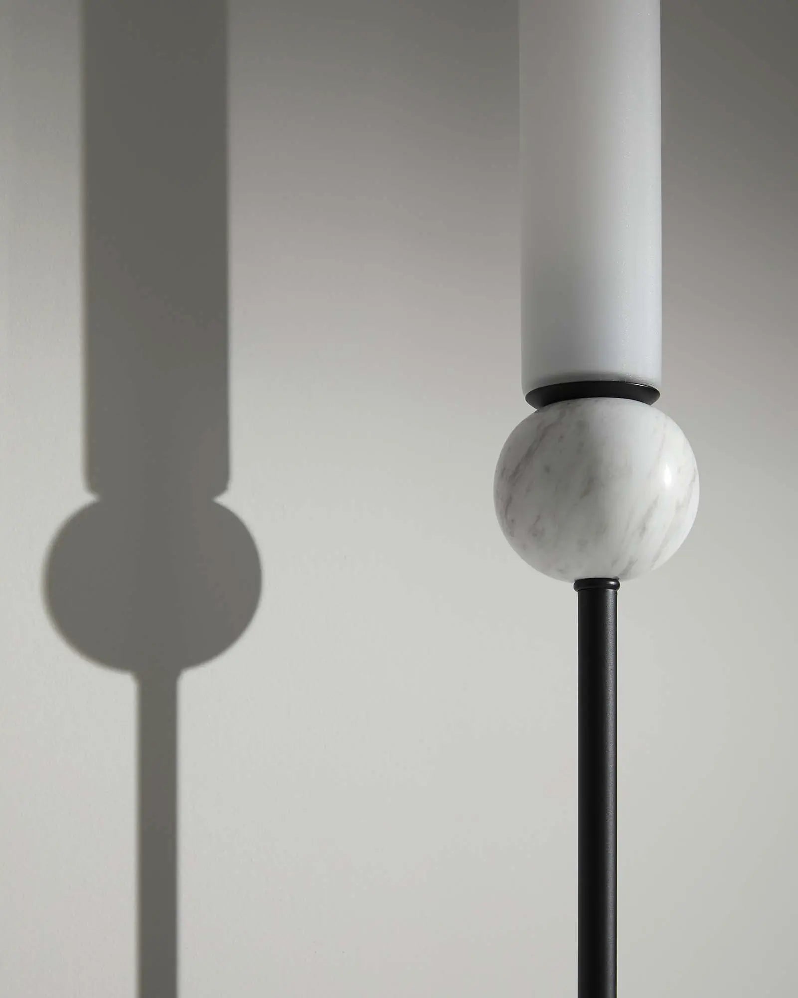 Delie Long wall light with marble white sphere and cylindrical opal shade black detail