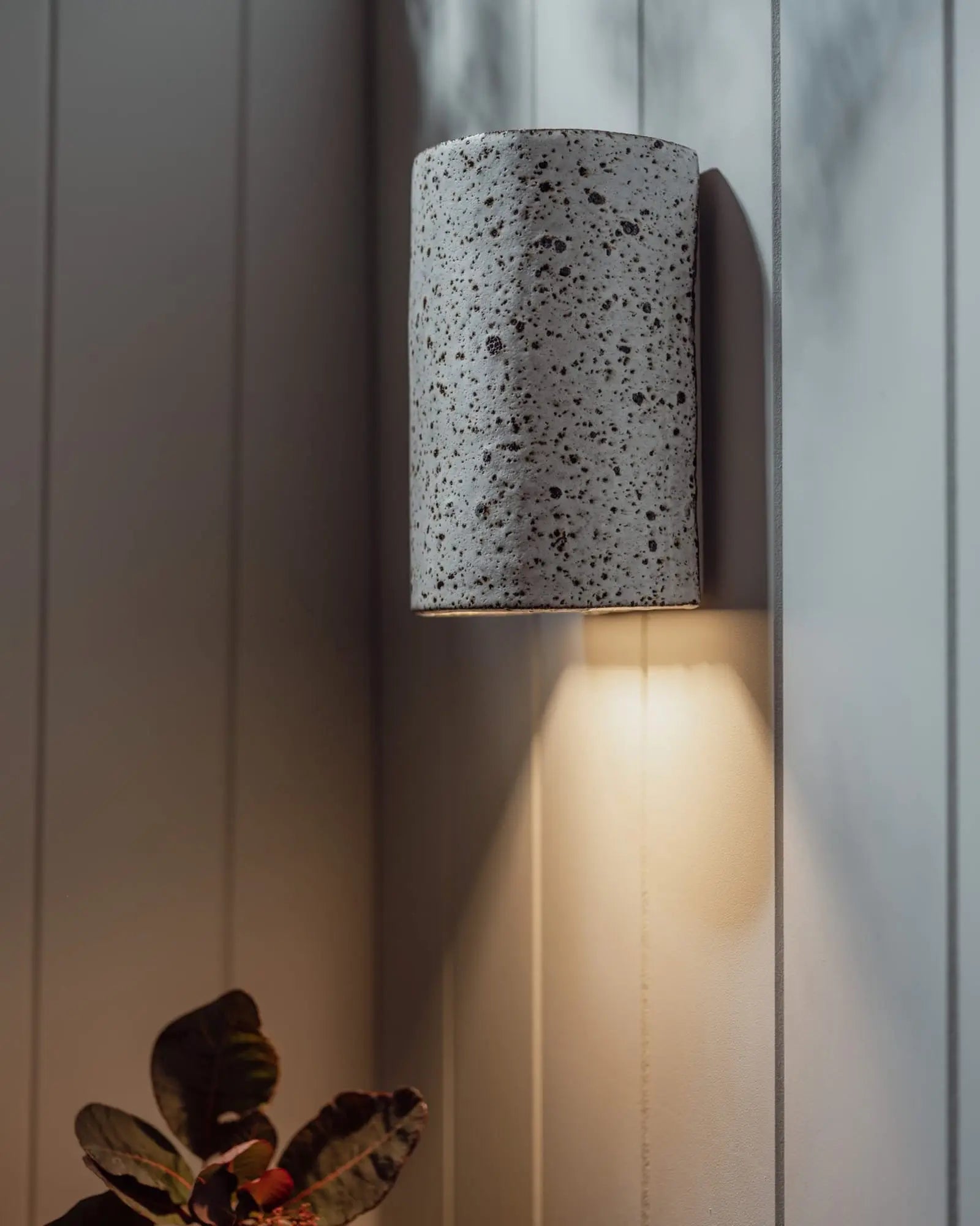 Dusk outdoor handmade ceramic wall light on cladded wall