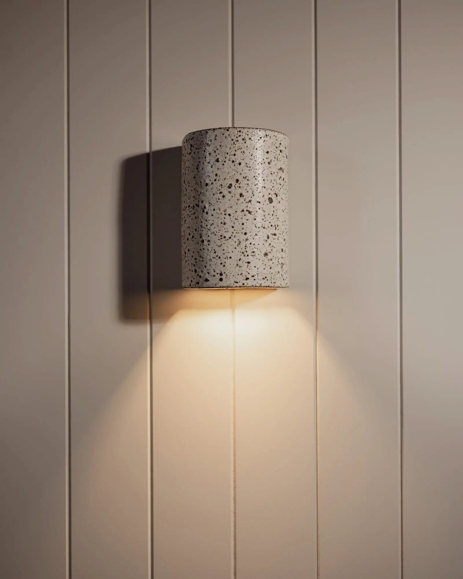 Dusk outdoor handmade ceramic wall light on cladded wall