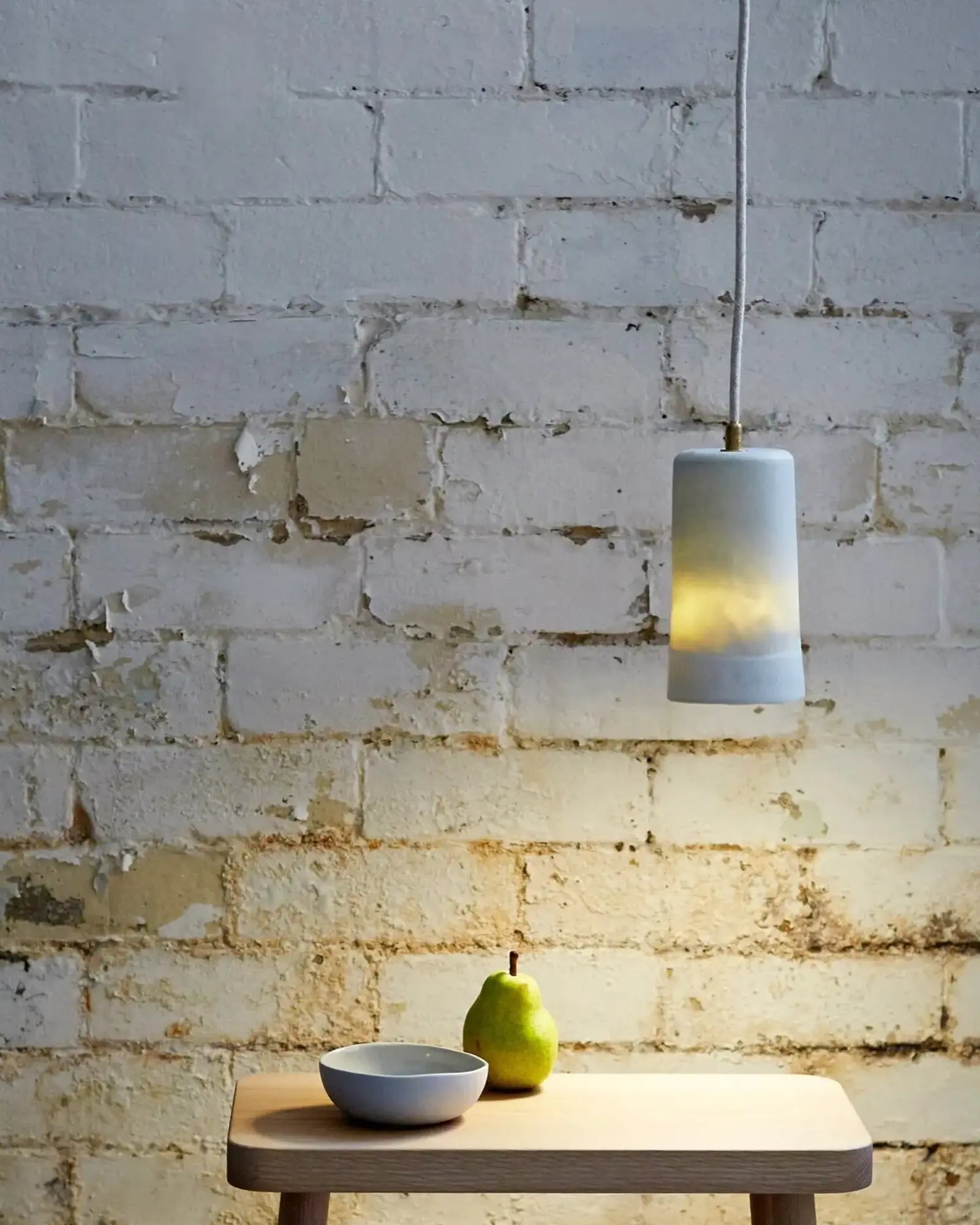 dusked pendant light above coffee table