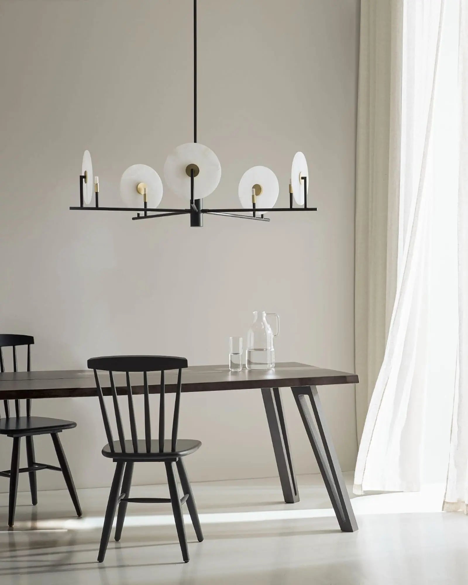 Erto 5 Light pendant discs above dining table