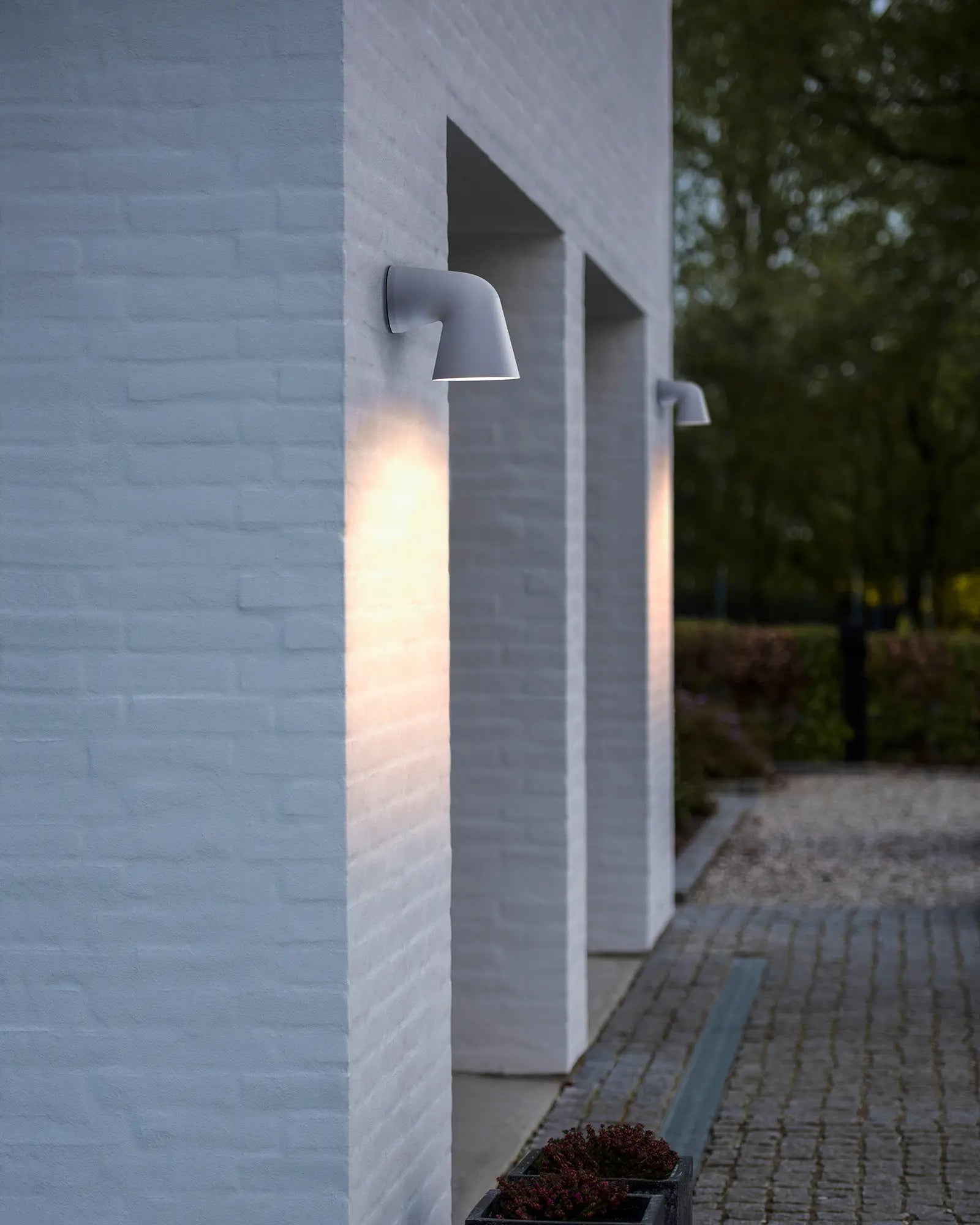 Front single Scandinavian outdoor light near a garage door