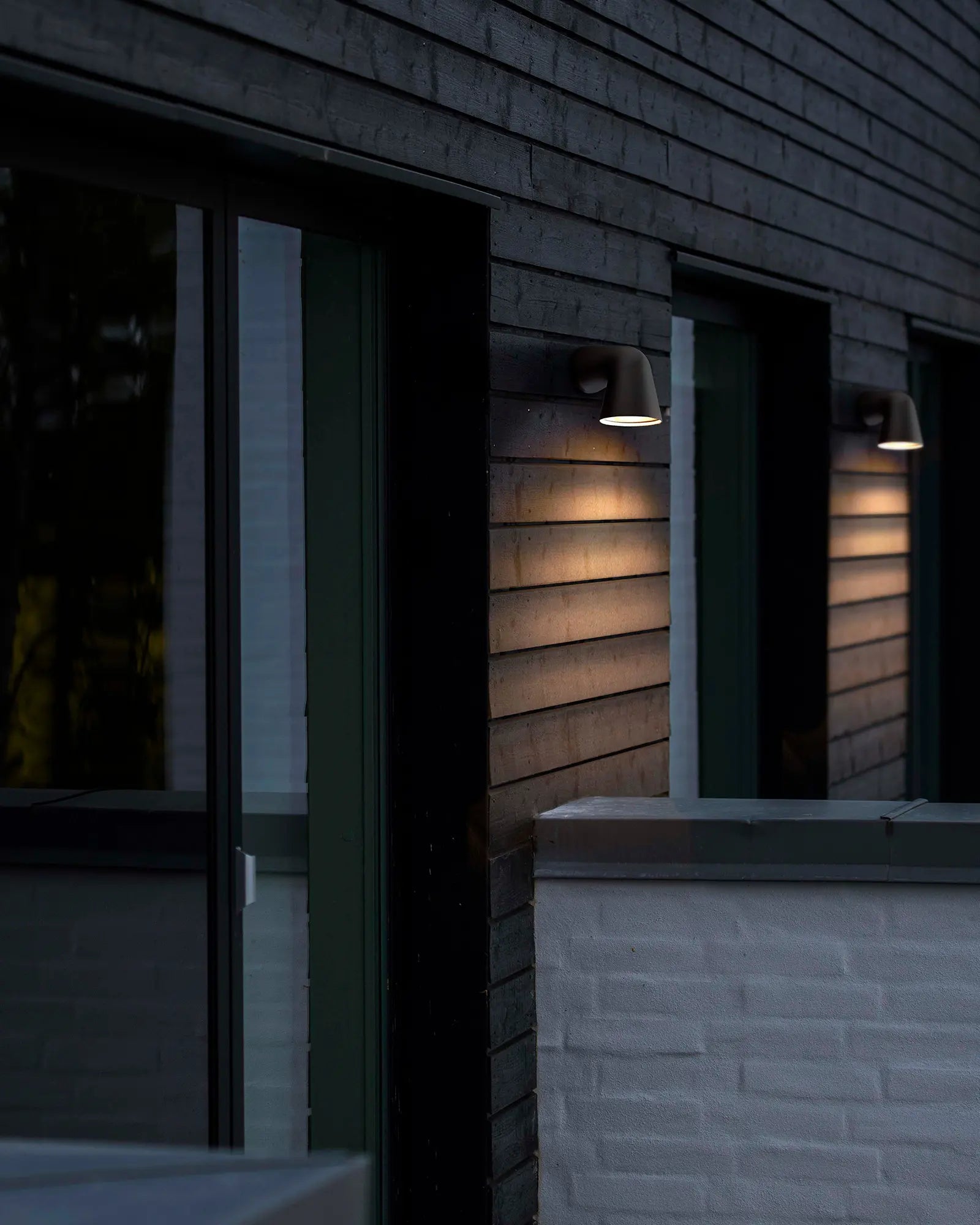 Front single Scandinavian outdoor light on cladded wall