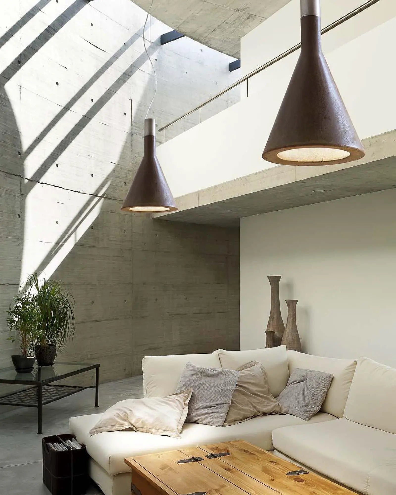 Funnel pendant light cluster above a living area