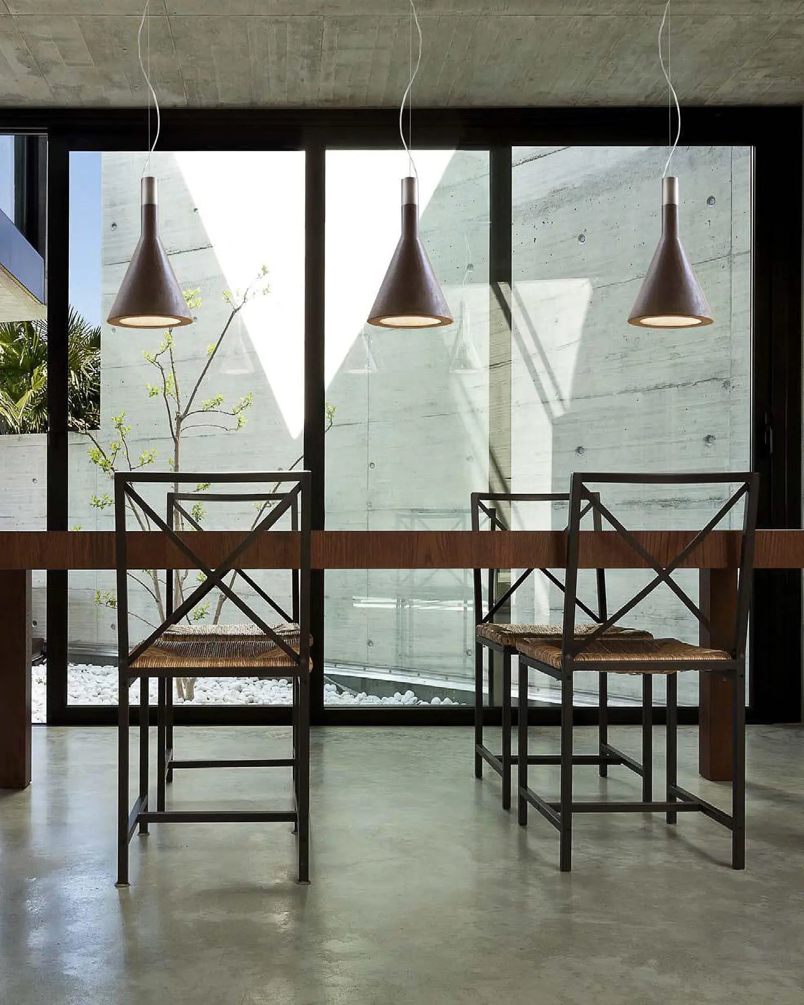 Funnel pendant light cluster above a dining table