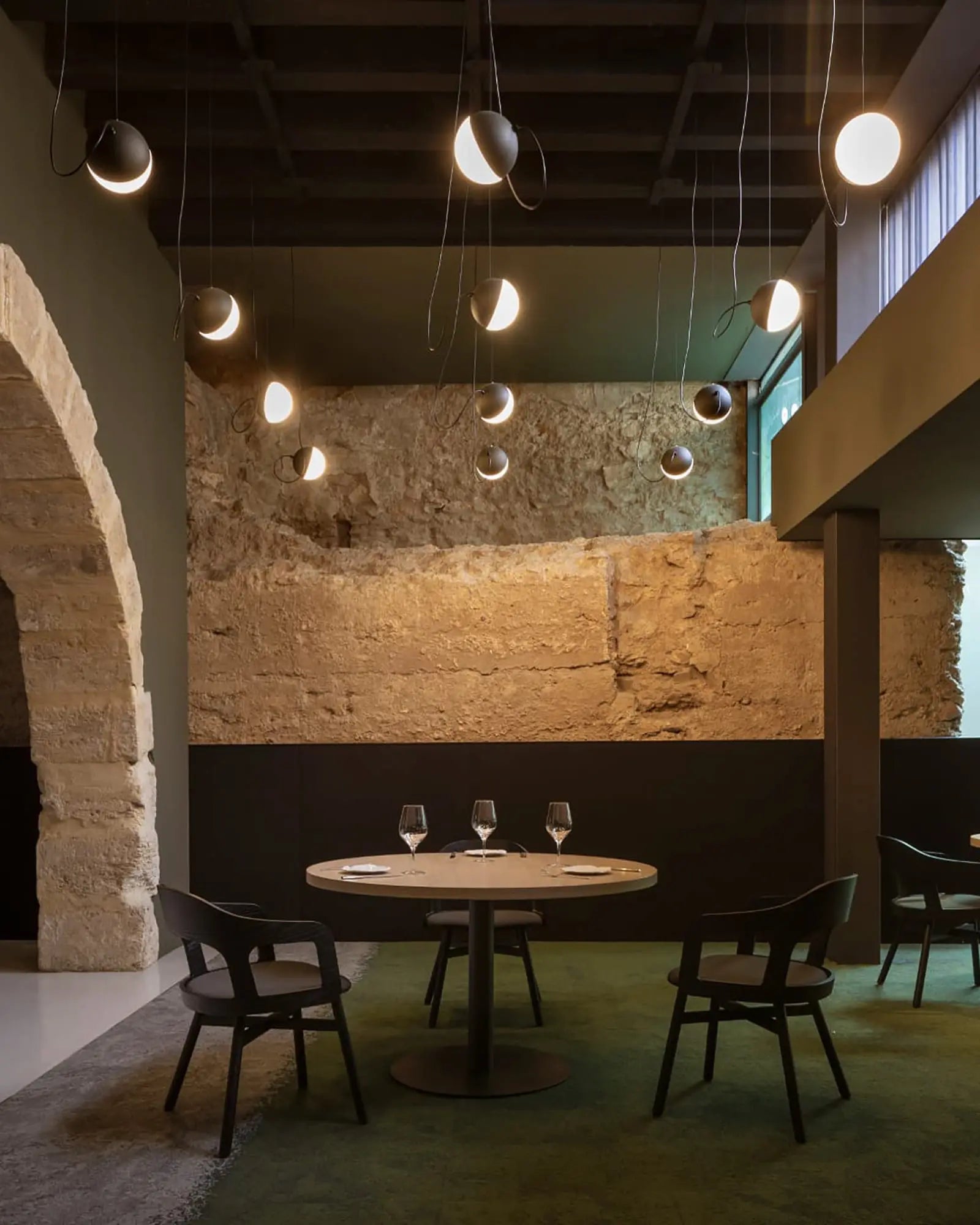 Half round minimal pendant light cluster above a restaurant table