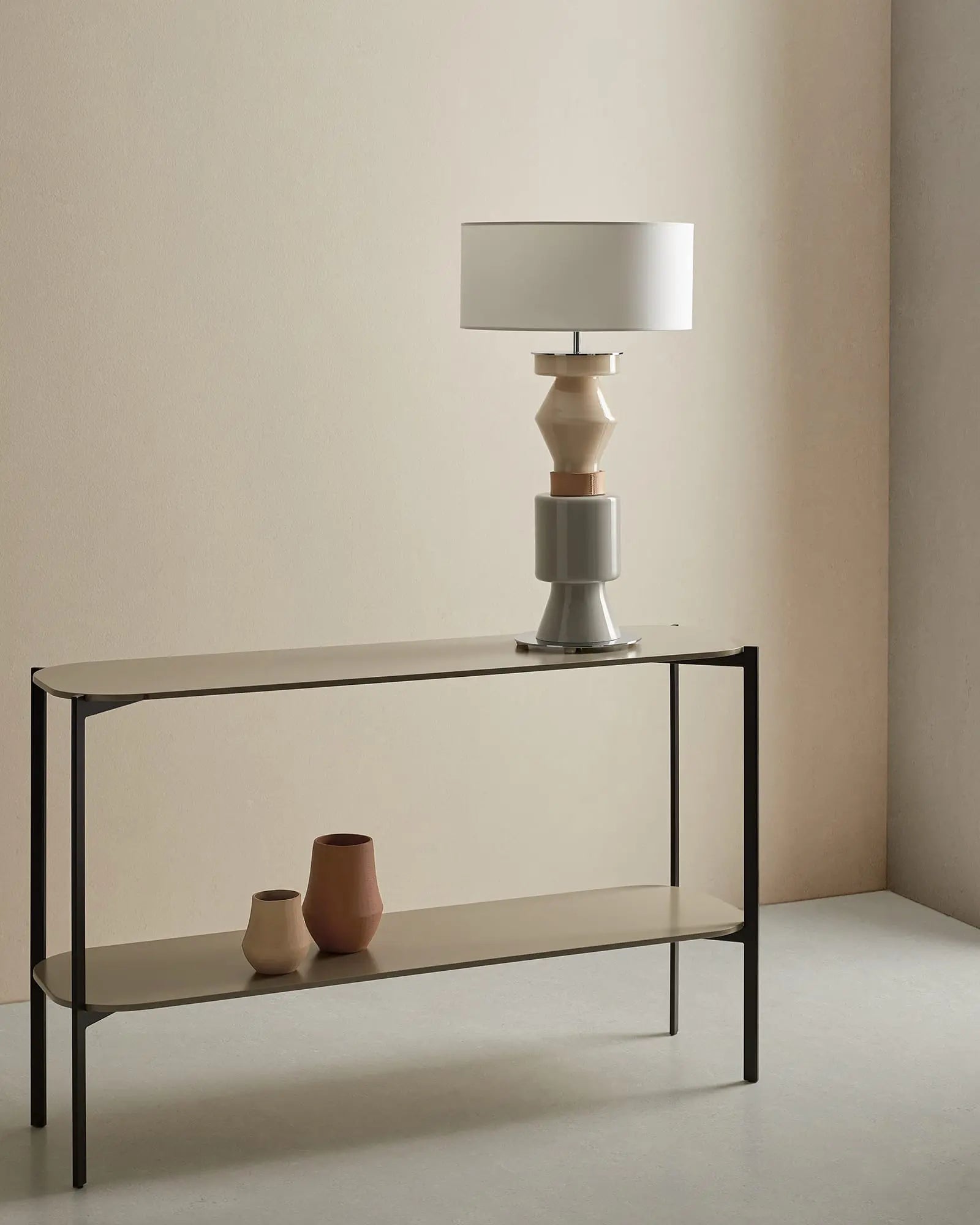 Kitta Ponn contemporary decorative table lamp in ceramic and fabric shade in living room over a bench