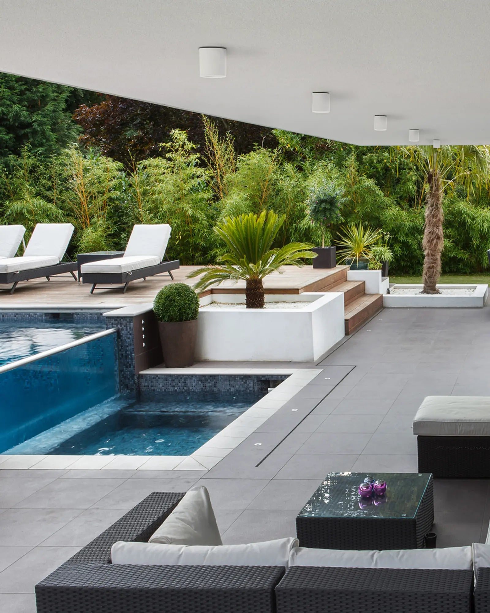 Kos II minimal cylinder metal downlight cluster above a swimming pool