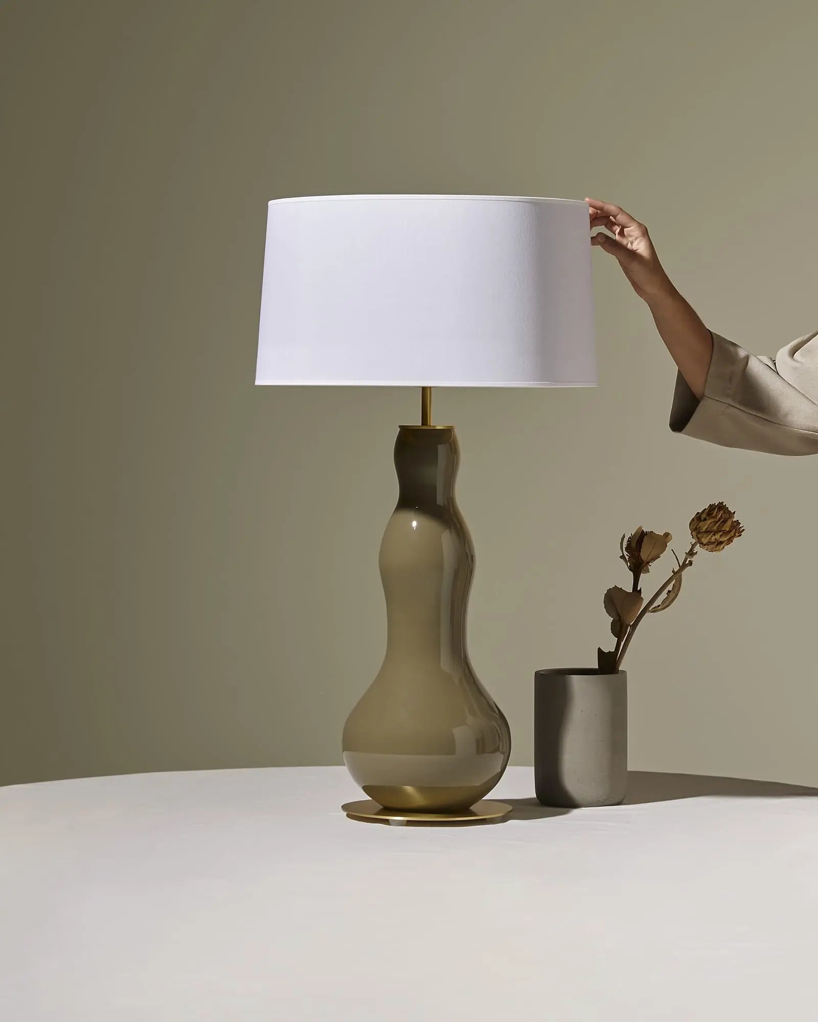 Melly Ceramic decorative table lamp with fabric shade on a table