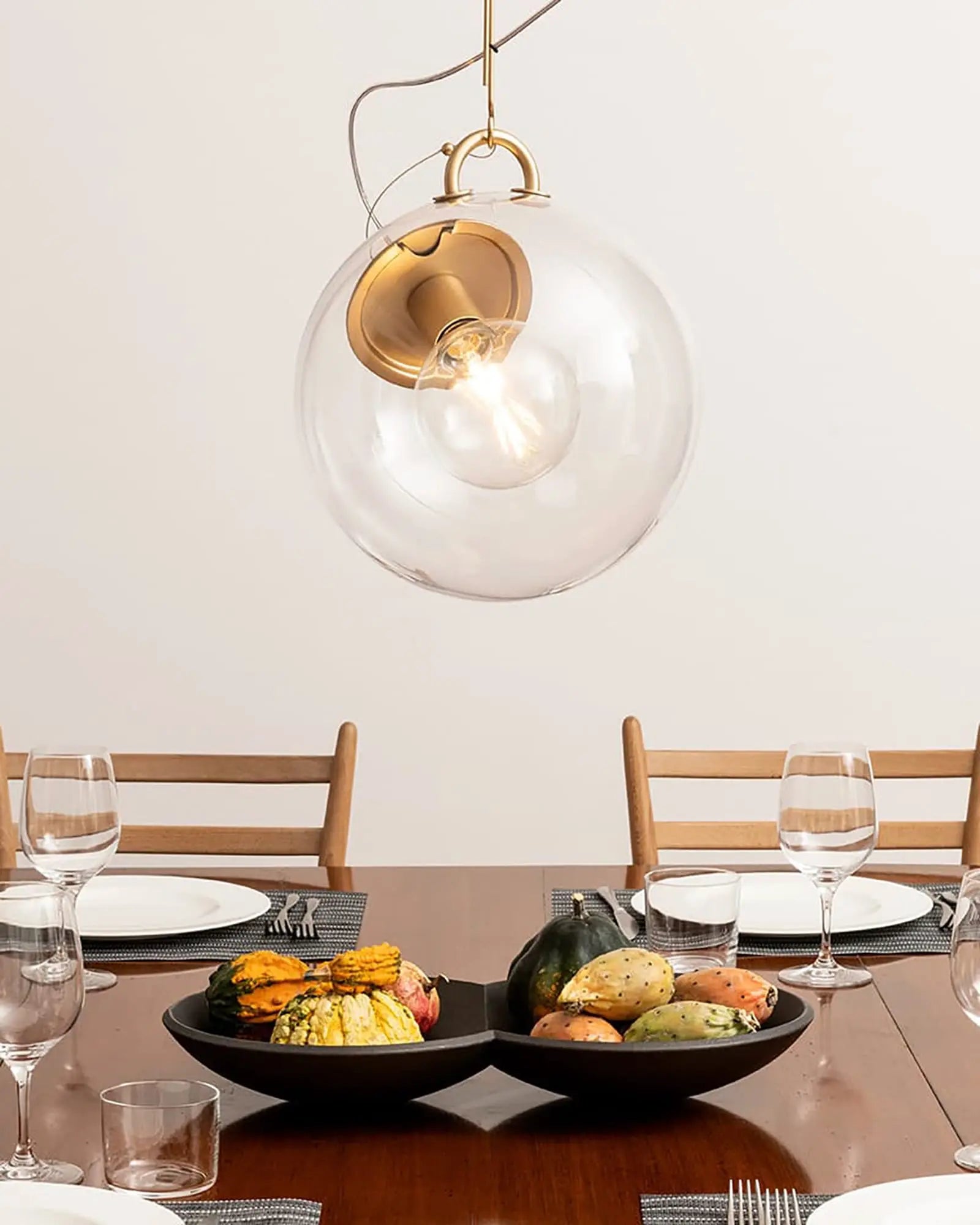 Miconos iconic designer blown glass and metal pendant light above a dining table